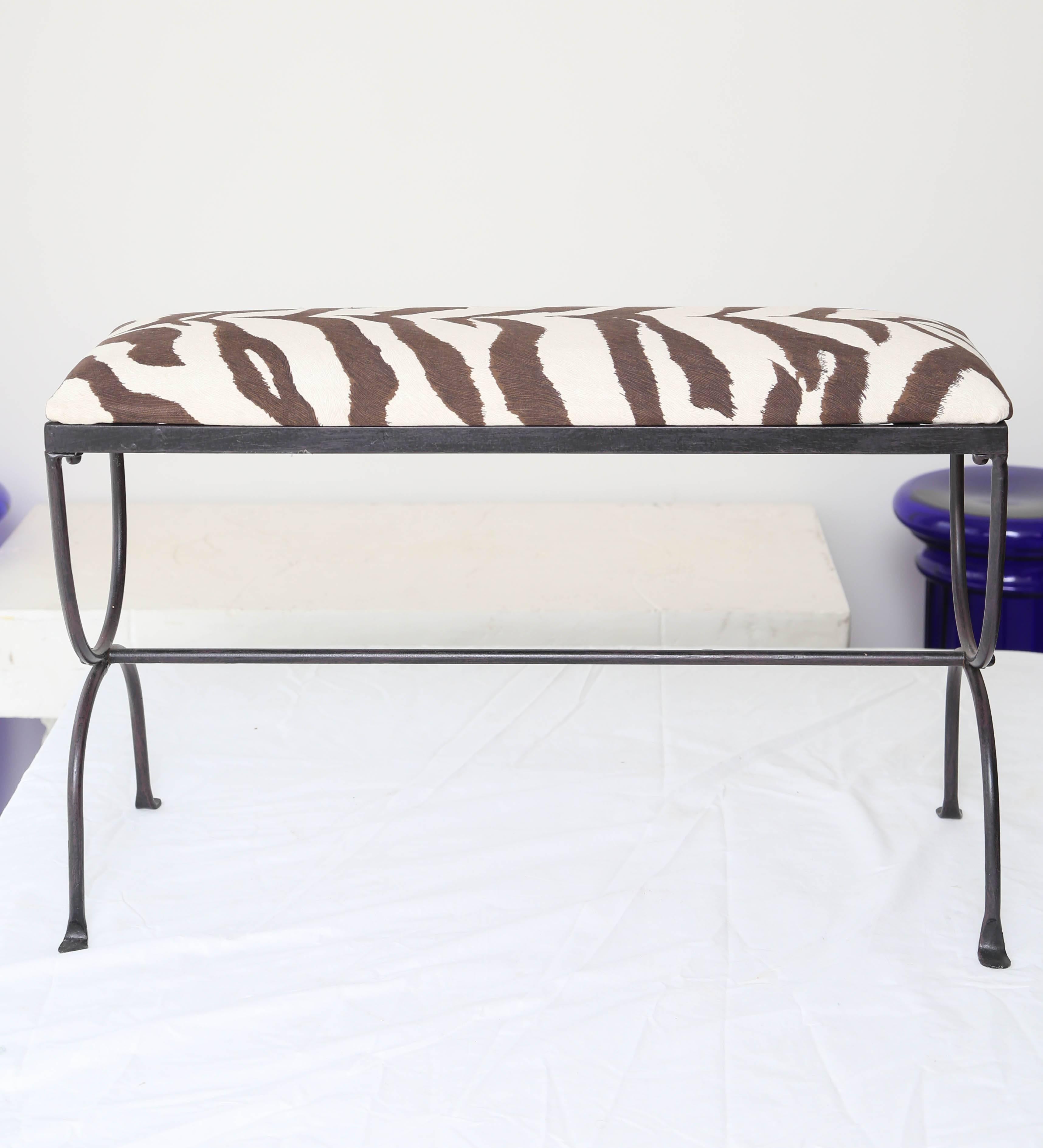 Zebra covered cushion on vintage black wrought iron bench.