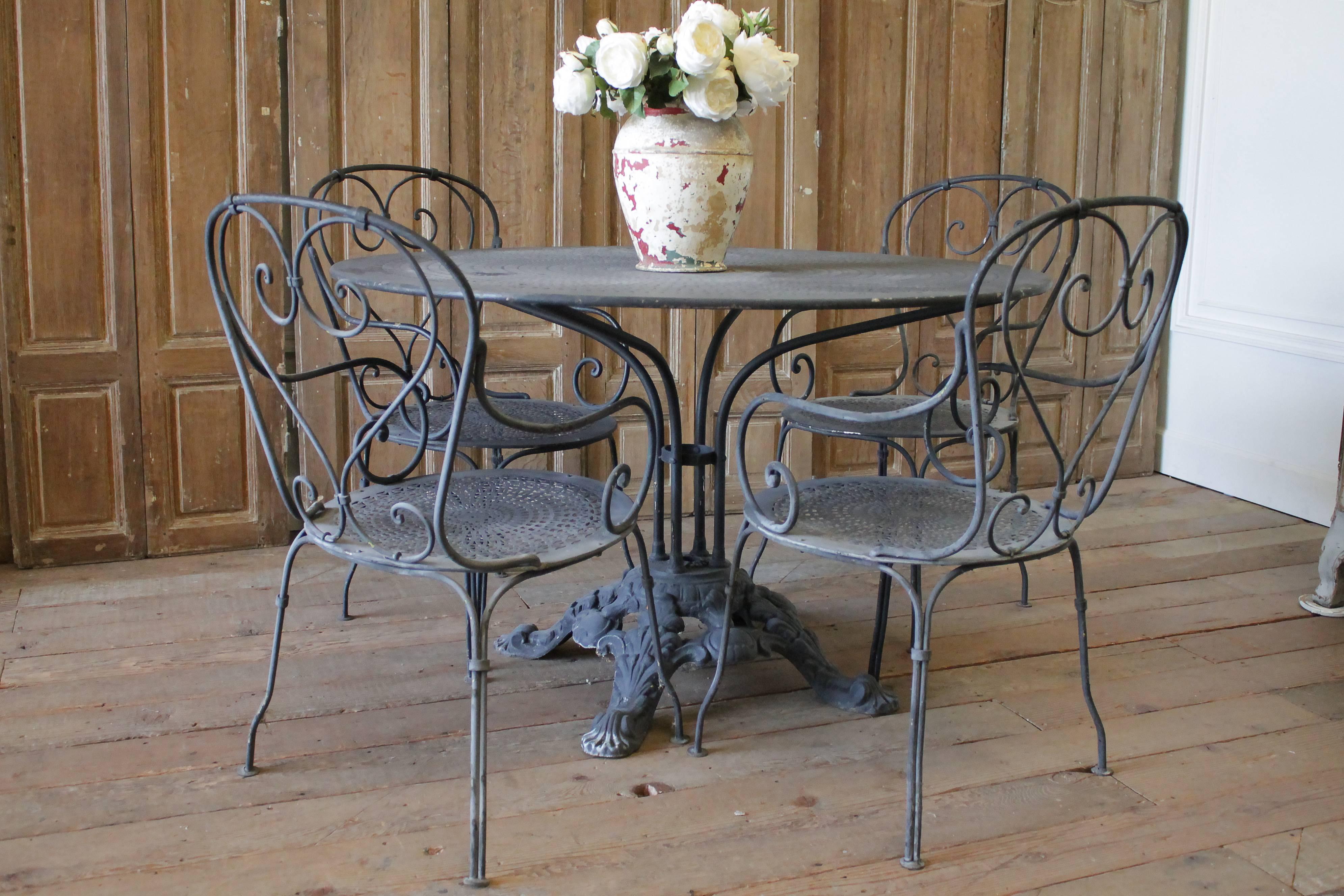 Black iron French Patio outdoor table and chairs
Original finish, faded black iron. Table has cut out design on the top, as well as the seats on the chairs. This round metal garden table was created in the 1880s and many of them used on the terrace