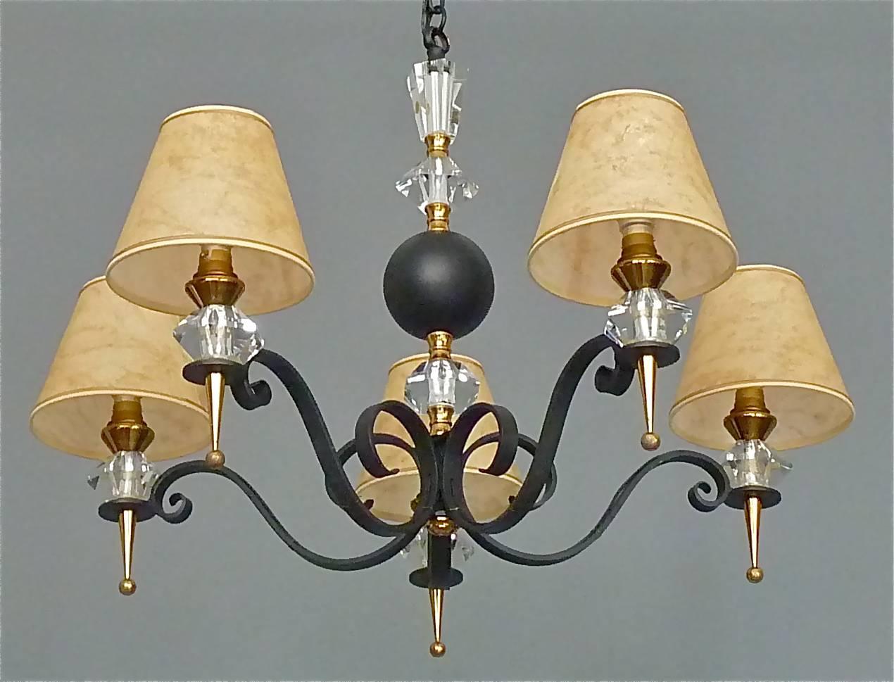 Gorgeous neoclassical black enameled wrought iron and metal midcentury chandelier, France, circa 1950s. Large chain-hanging height adjustable five-scrolled-arm chandelier with nice gilt brass metal details and beautiful faceted and hand-cut crystal