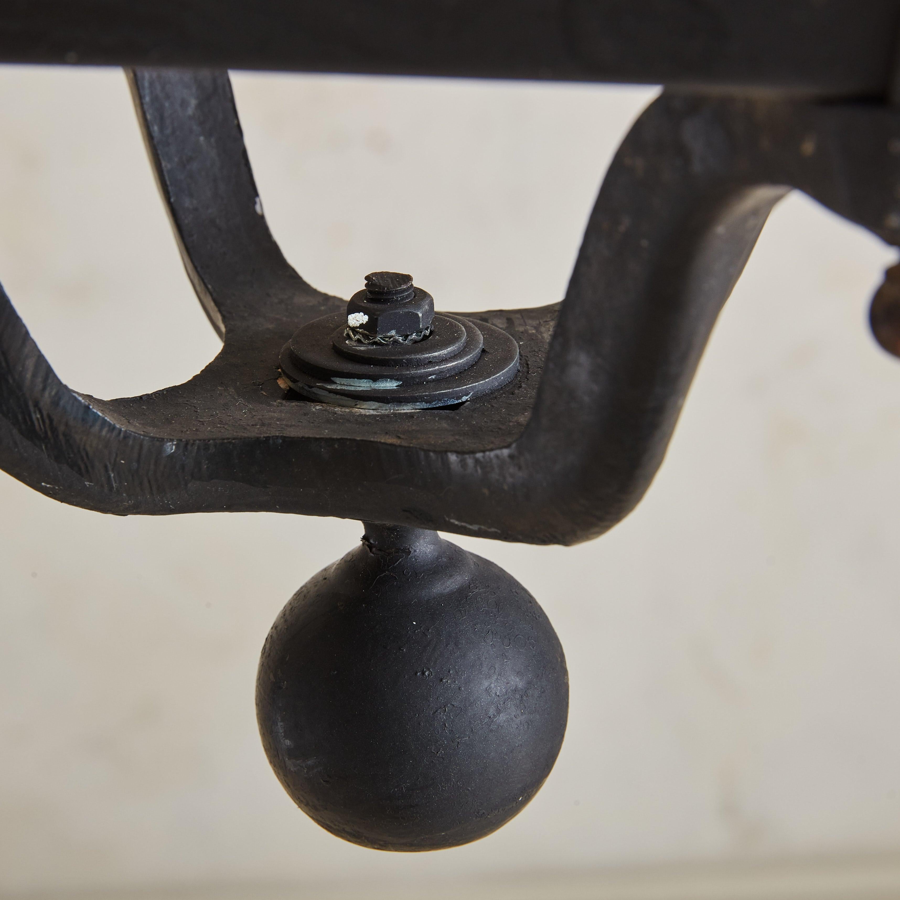 A monumental 1960s French lantern featuring a classic profile constructed of black iron with a natural, aged patina. This fixture has four tapered glass panels and an elegant ball finial detail along the scrolled base.

These lanterns were sourced