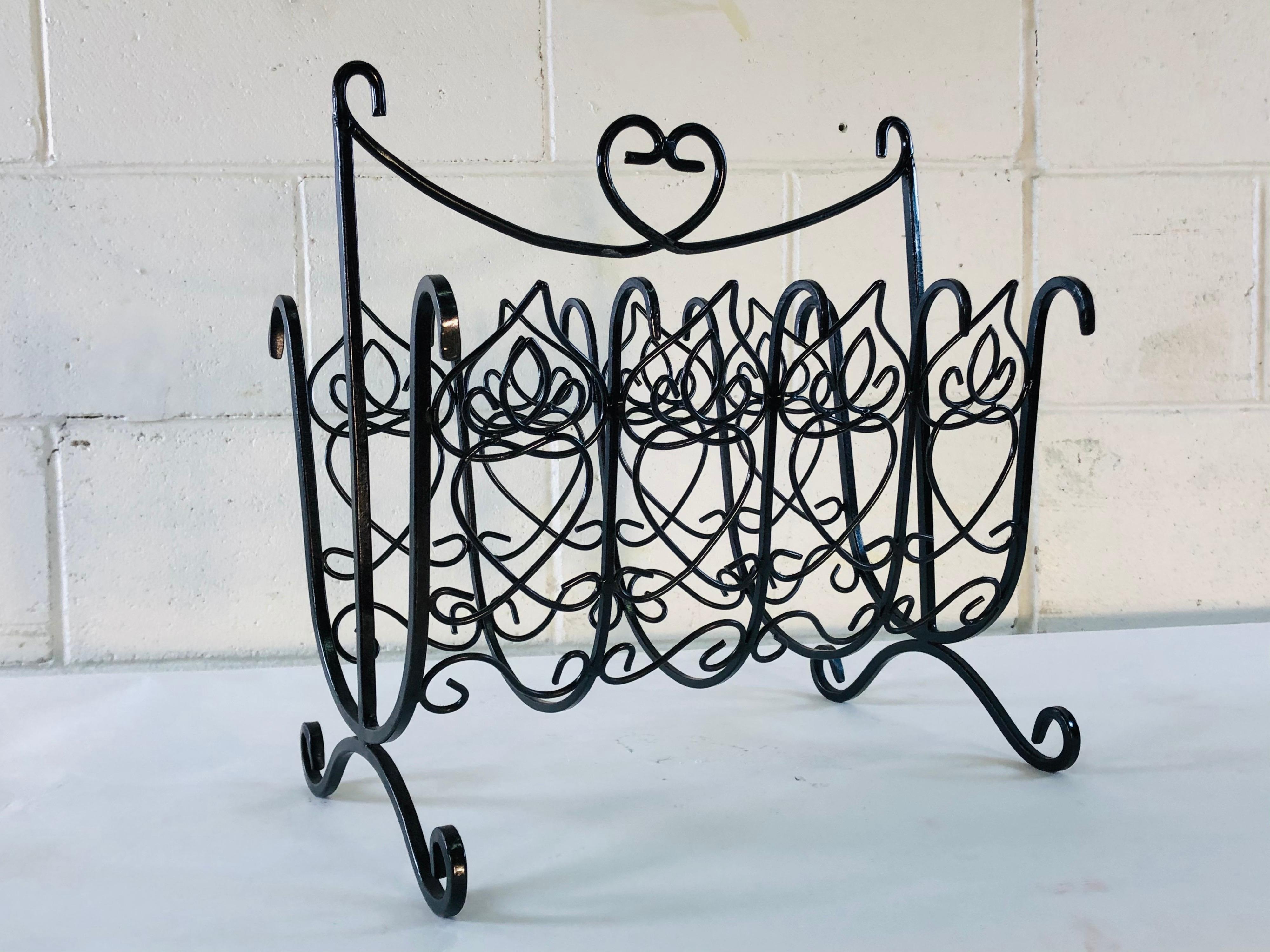 Vintage 1960s black iron handled magazine rack with a heart handle. Beautifully designed rack with an intricate design. Excellent condition. No marks.