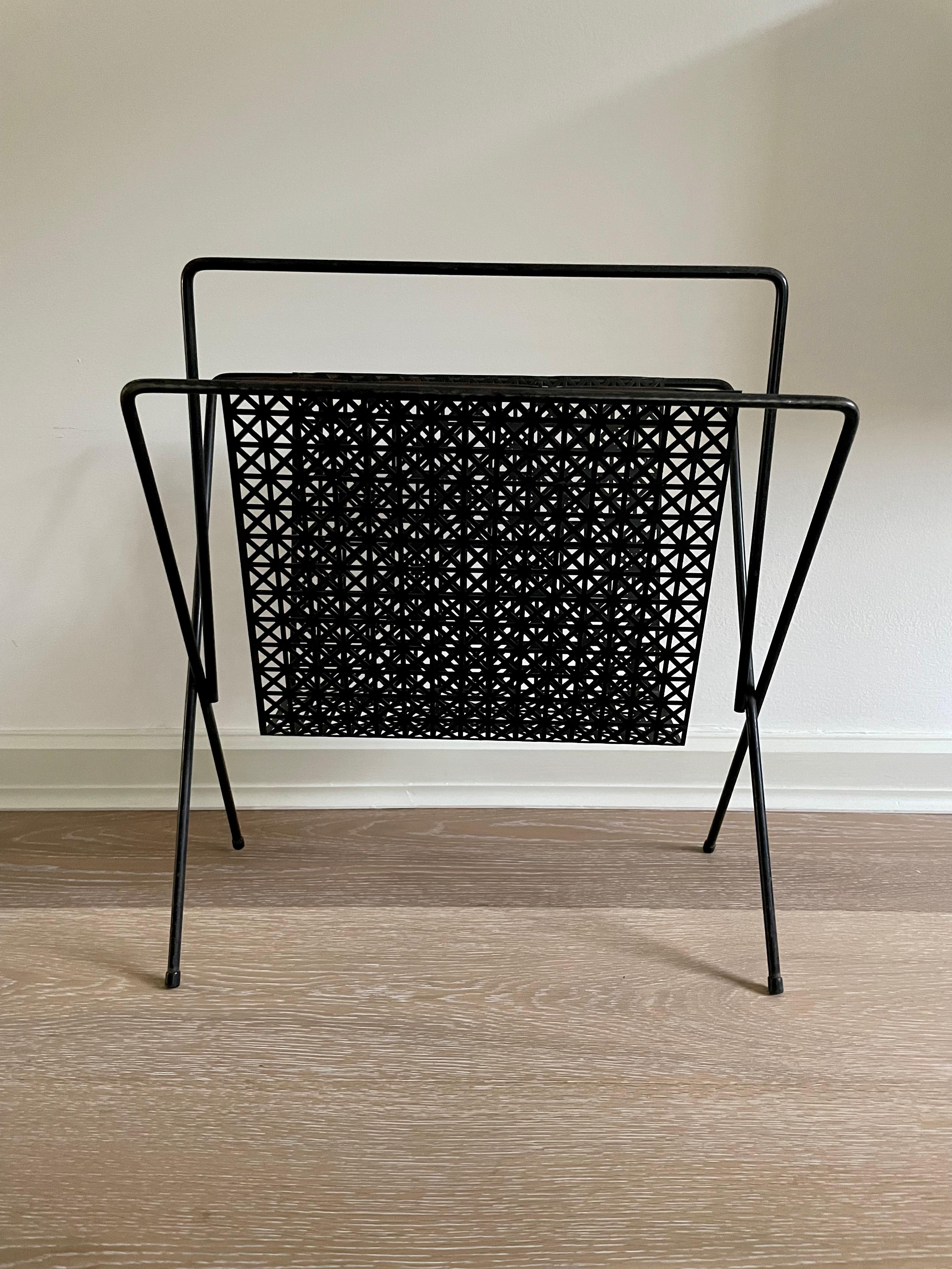 Black Iron Magazine rack in the Style of Mathieu Matégot.

Classic Matégot style perforated bent metal magazine rack in black.

Some wear consistent with age and use, but it adds to the items overall charm and antiqued aesthetic.