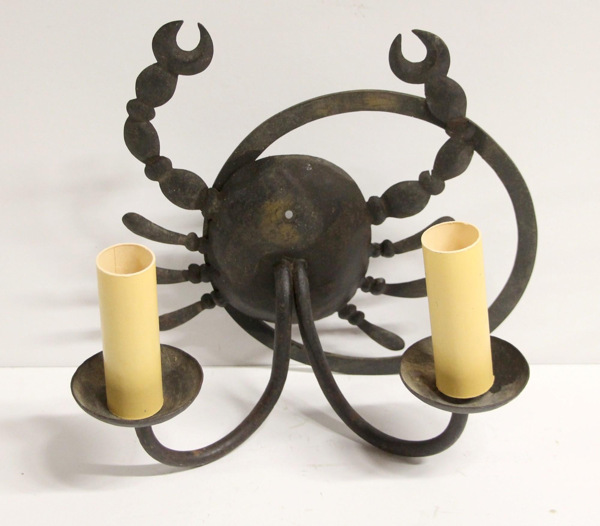 Unusual black iron wall sconce in the shape of a scorpion. Uses two household light bulbs. One available.
