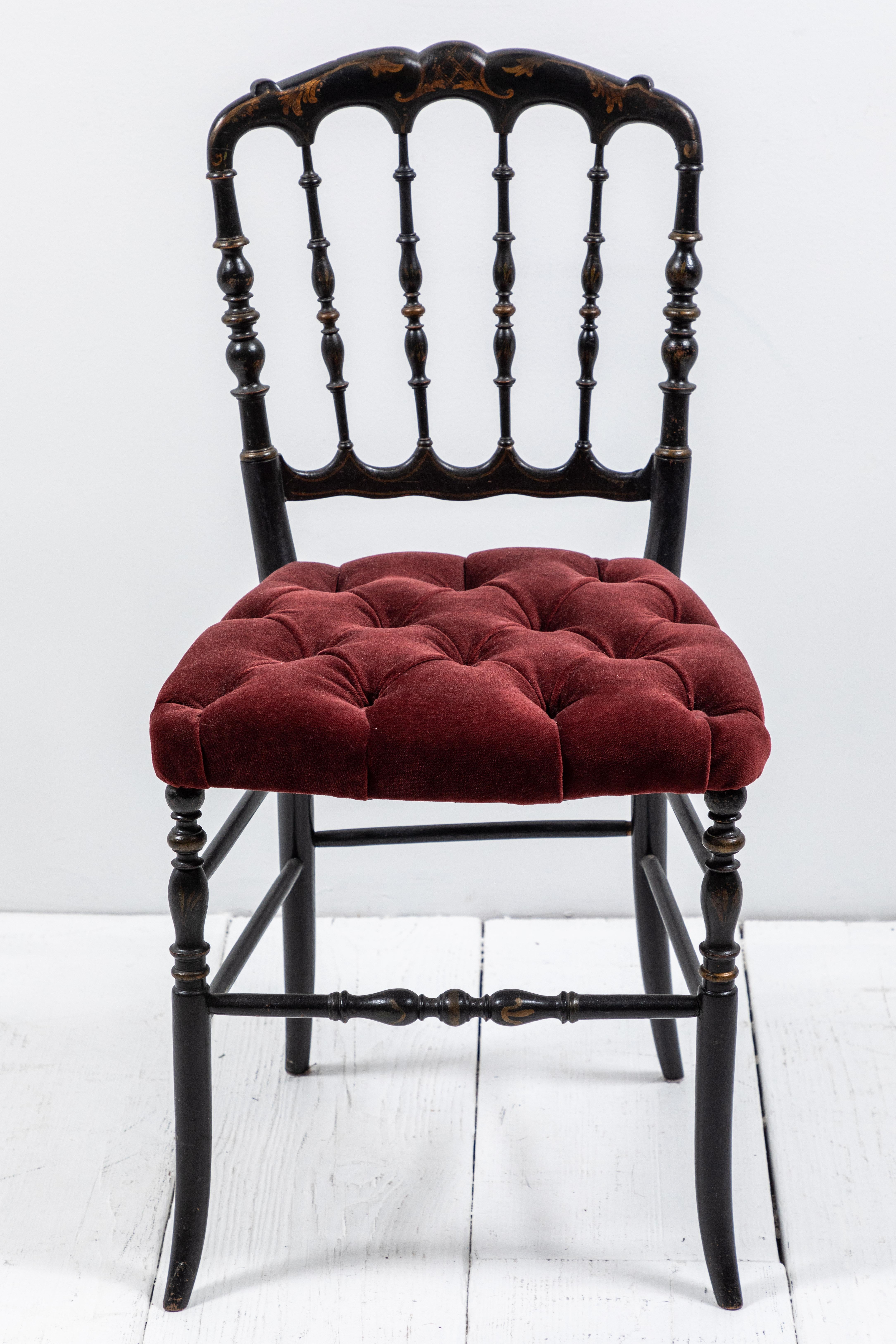 Petite Italian Chiavari chair with gold scroll work painted on the frame. The burgundy velvet is newly upholstered.