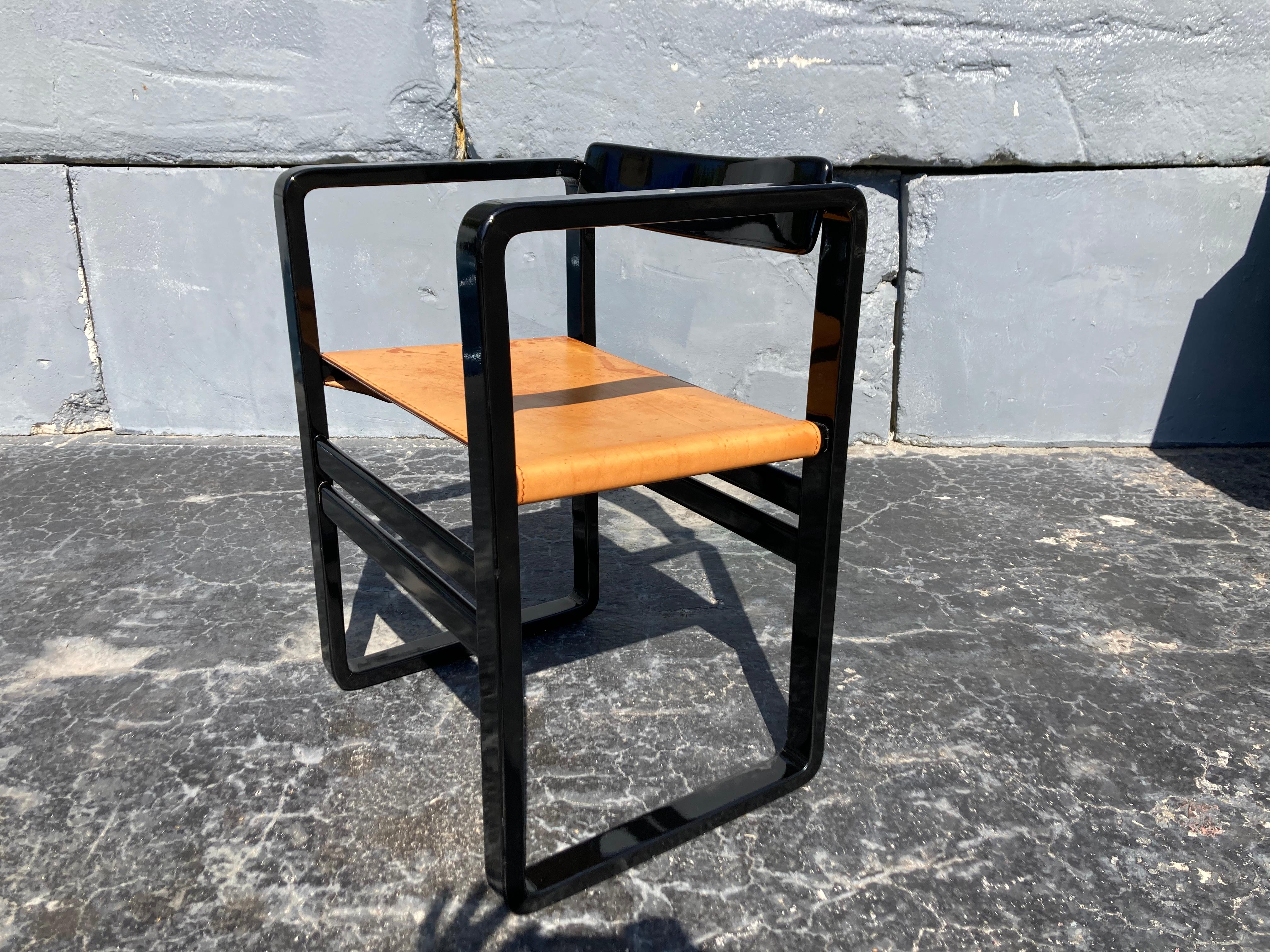 Black lacquered wood arm chair with beautiful saddle leather seat, the back swivels.
Arm height is 27”.