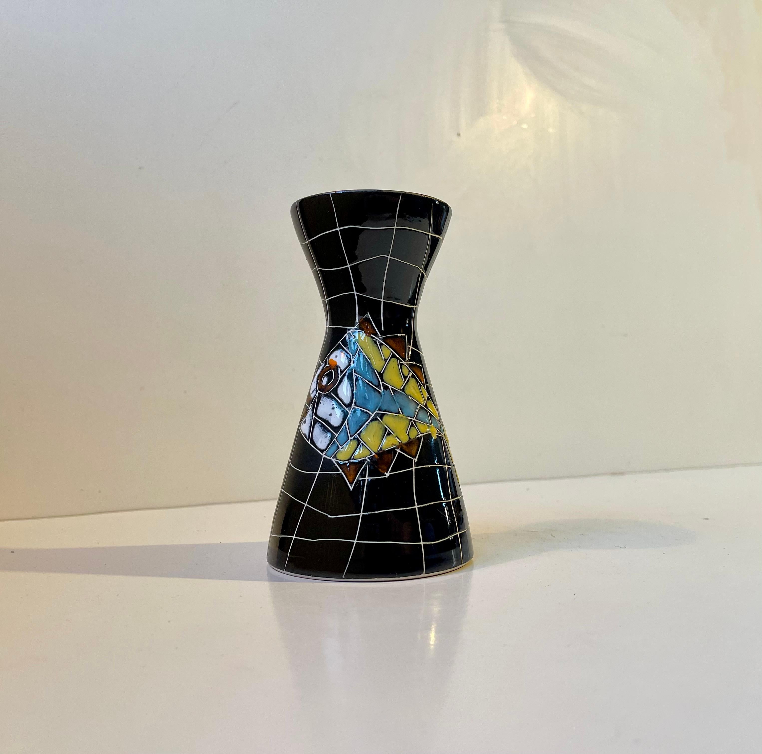 The playfulness and naivety of this black diablo vase reminds us of a piece by Guido Gambone we had a few years ago. It is executed in black glazed porcelain with white unorganized lines/squares. In the middle adorns a rather whimsical or naively