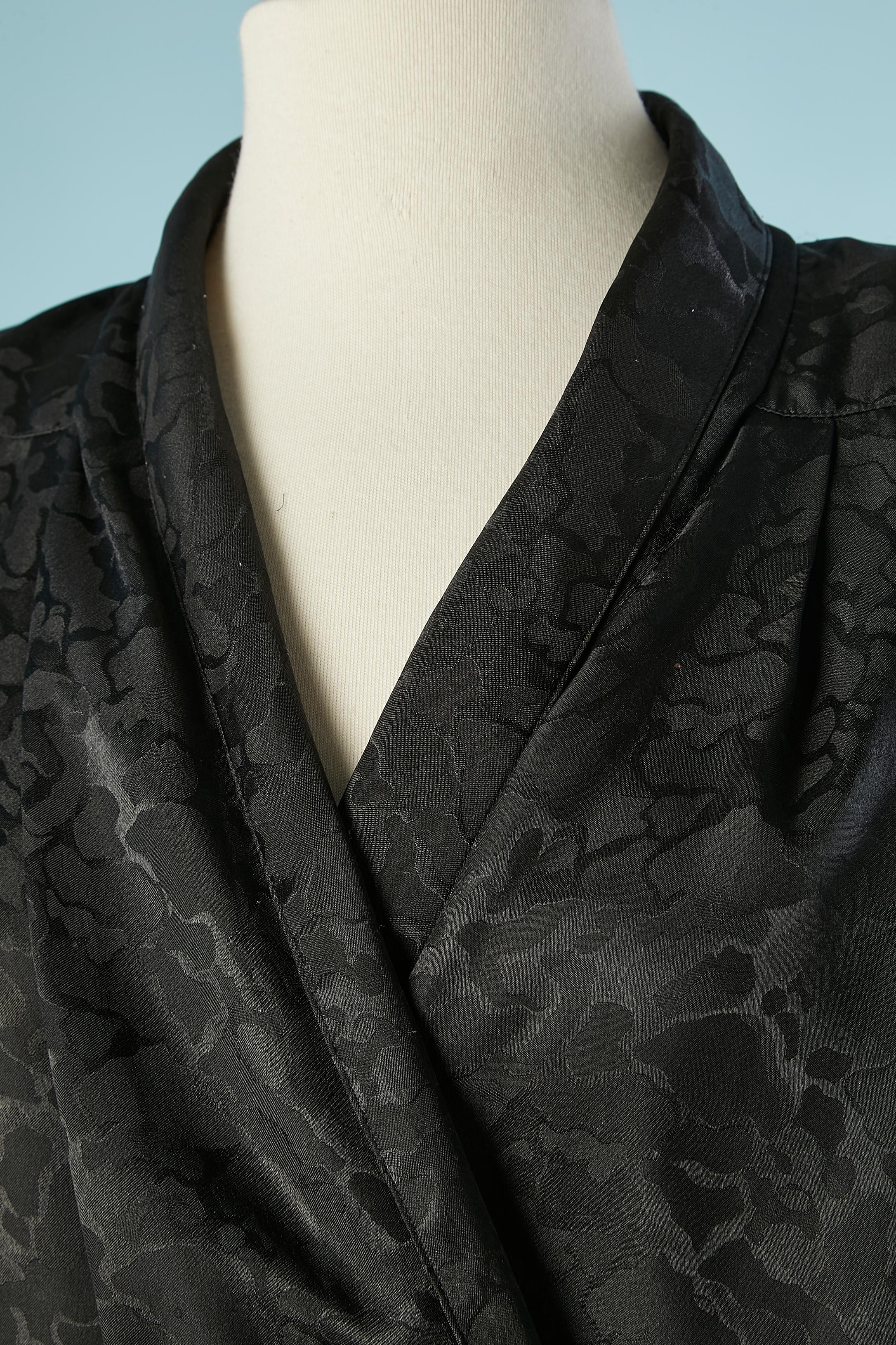 Black jacquard wrap shirt . Fabric composition: 100% polyester. 
Snap and hook&eye closure in the front and bow. Buttons and buttonholes on the cuffs. Shoulder-pad. 
SIZE 8 / 38 (Fr) / M 
