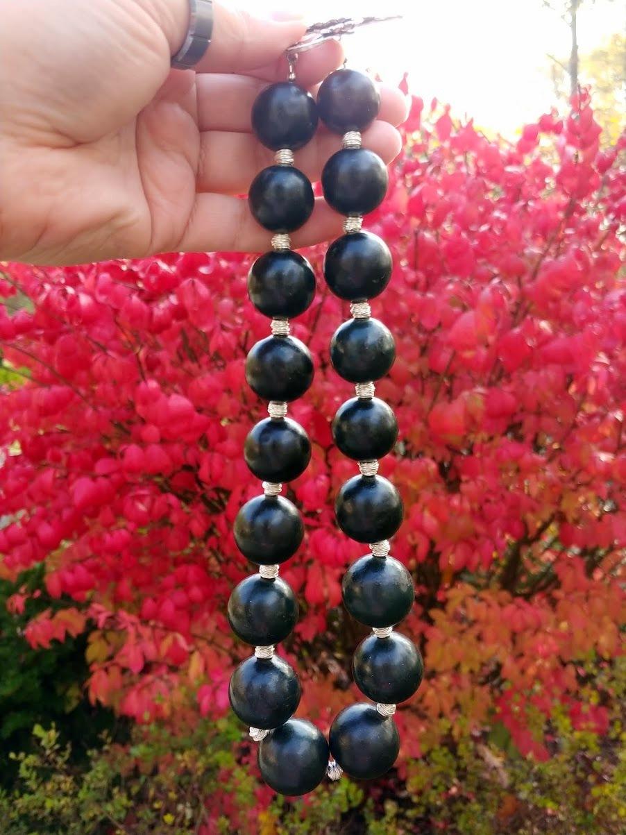 This Black Nephrite from the Eastern Pamir.

The length of the necklace is 20.5 inches (52 cm). The rare size of the smooth beads varies from 20 mm to 25 mm.

The color of the beads is opaque matte black. With different lighting, the color varies