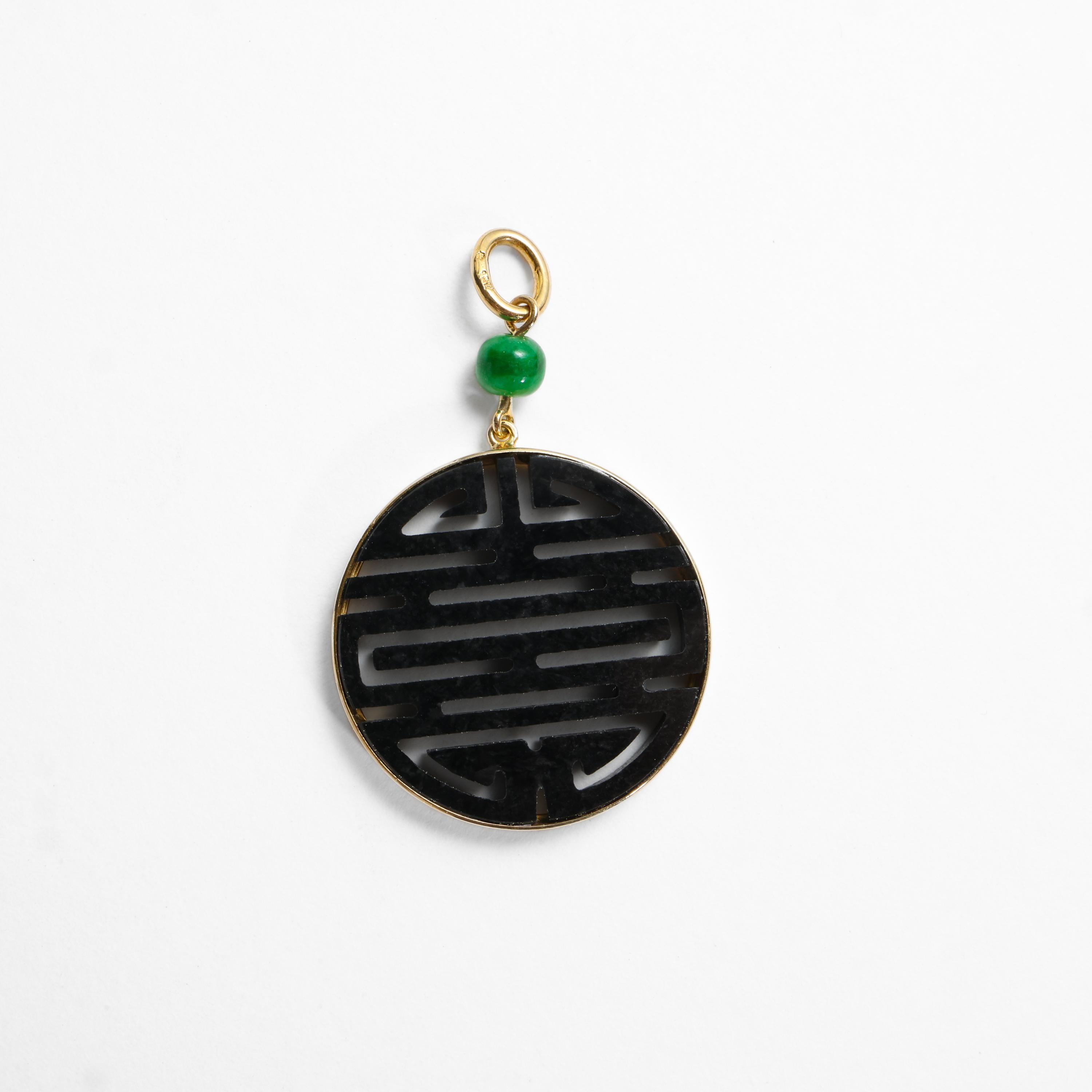 This black jade pendant features a disk of natural, untreated jade pierced with the characters for 