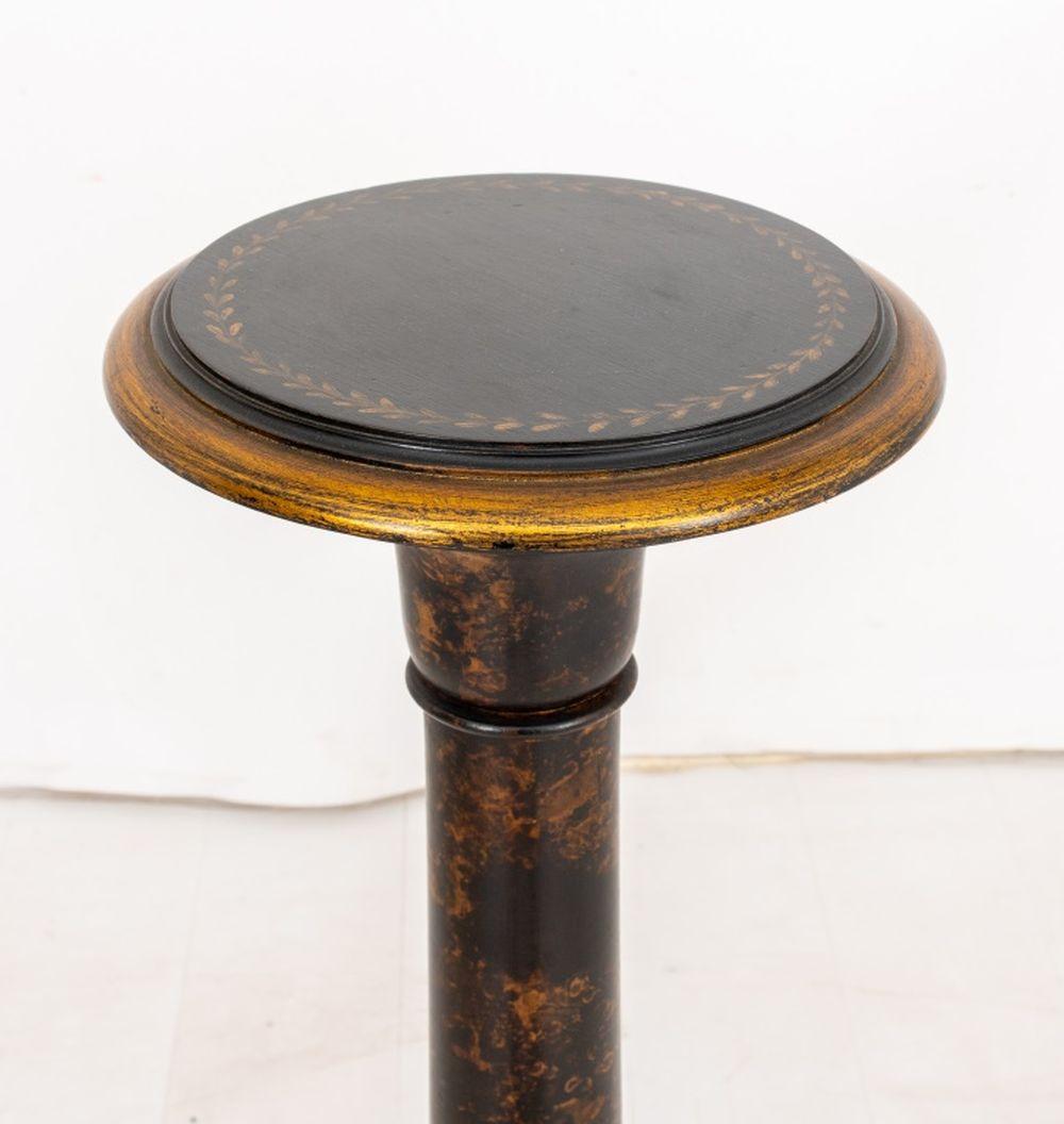 Black Japanned and Parcel Gilt Pedestal, of columnar form with circular top and base, the sides lightly mottled with gilding and laurel leaf motifs to top. 39