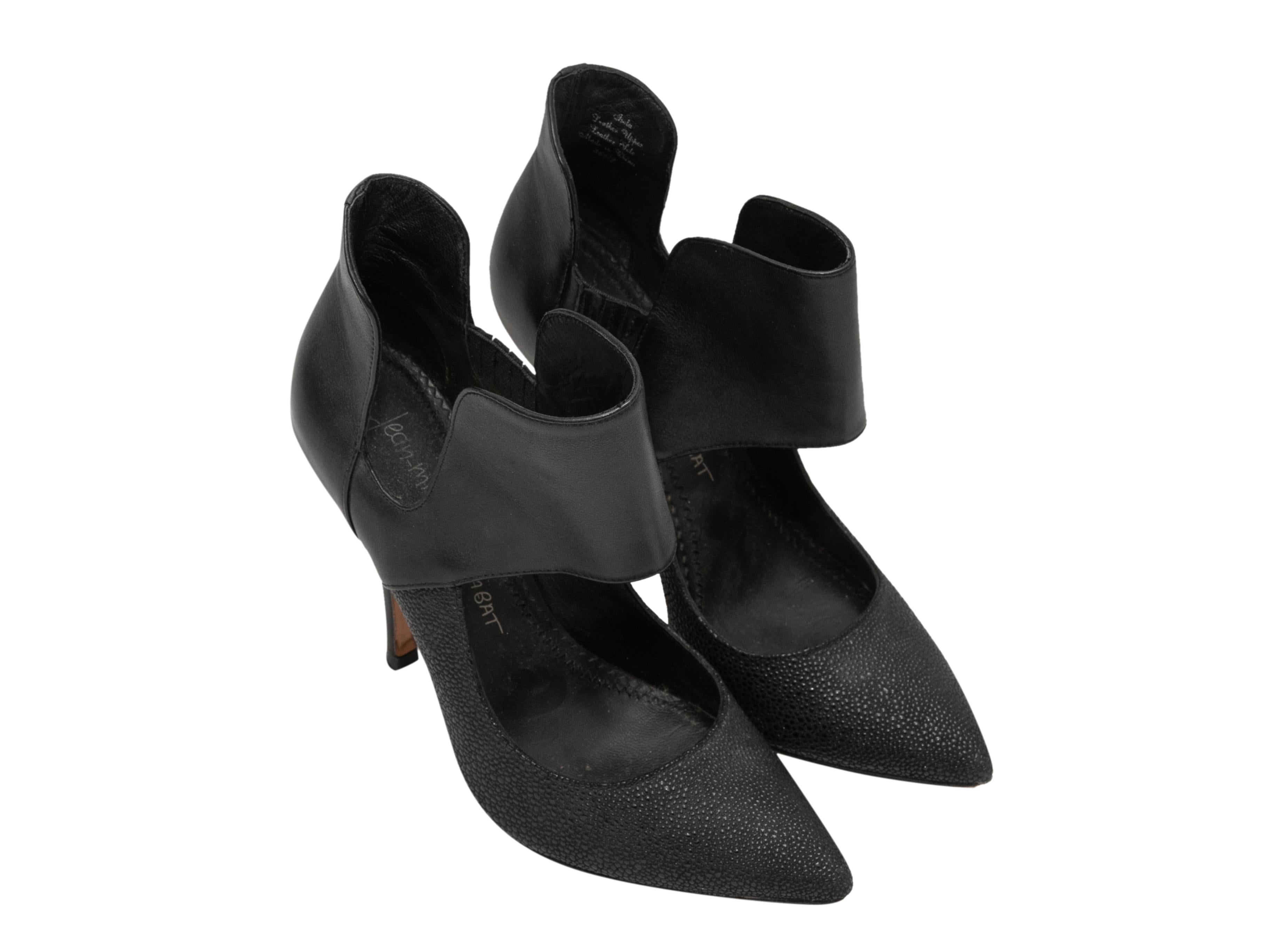 Black leather pointed-toe cutout booties by Jean Michel Cazabat. Elasticized gores at sides. 3.5