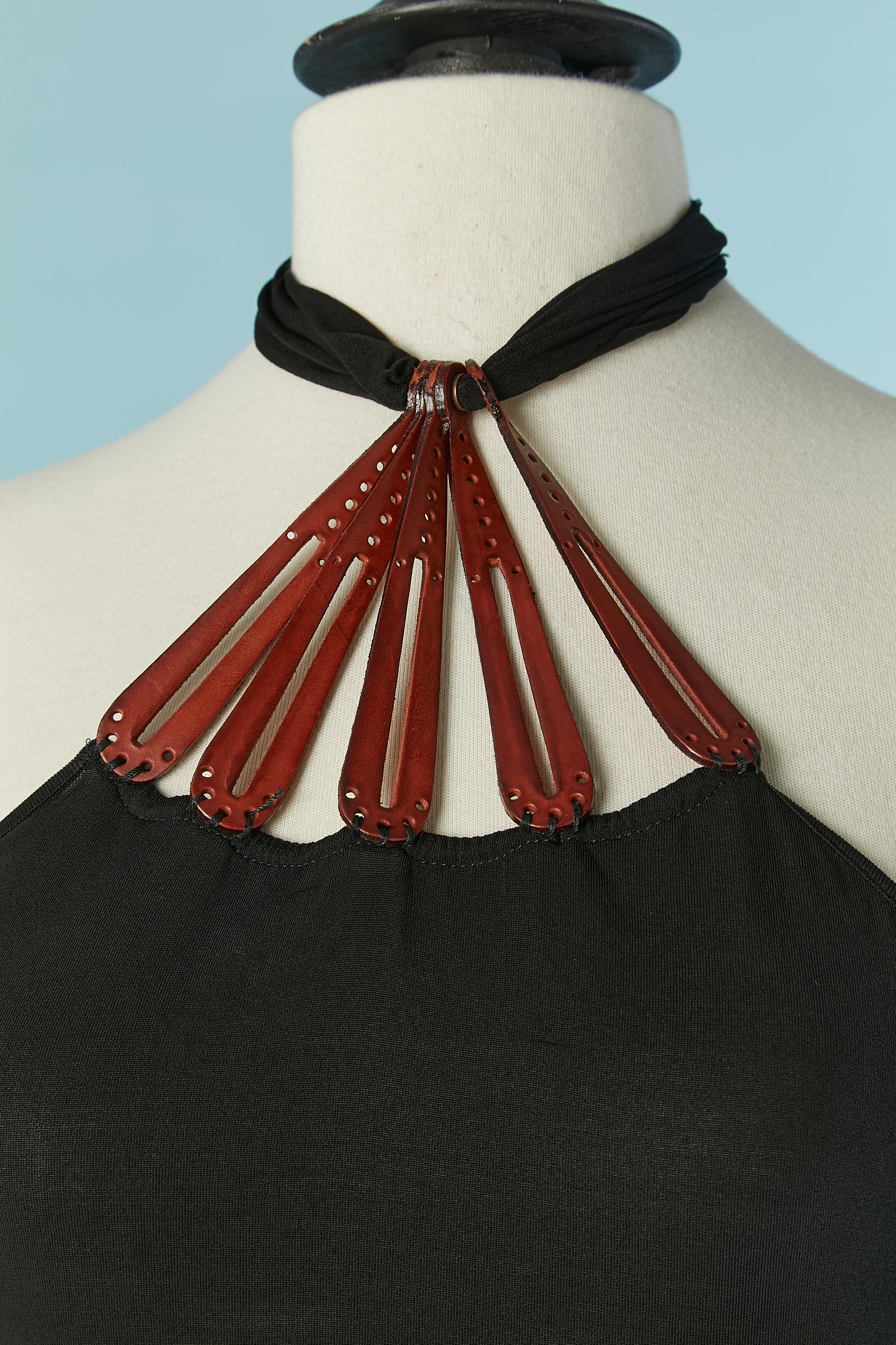 Vestido sin espalda de punto negro con detalle de cuero en el escote. No hay etiqueta de composición del tejido pero probablemente sea un jersey de rayón ( muy fino) 
Atado detrás del cuello. 
TALLA M 
