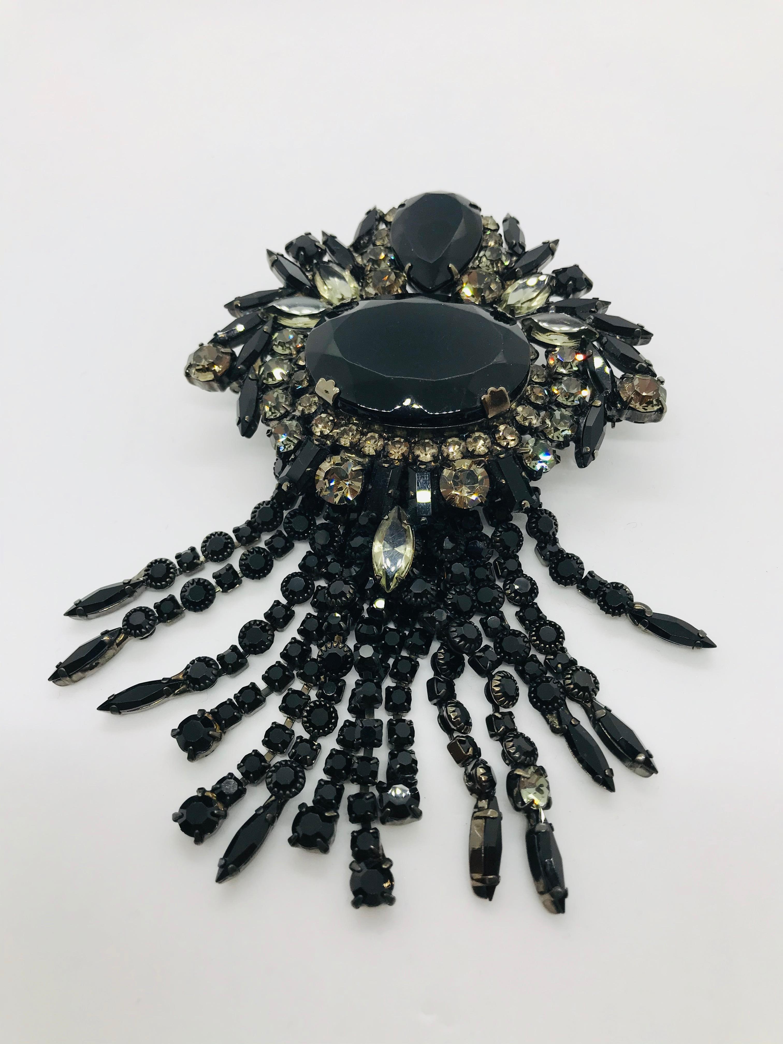 This large and dramatic black jet and black diamond Austrian crystal brooch has a distinct 