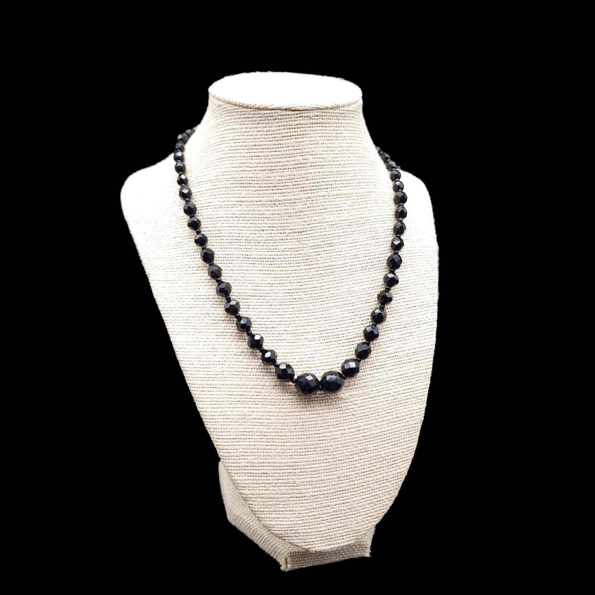 Necklace length: 17.5 in. / 45 cm plus 2 in. / 5 cm extension
Largest center bead approx. 1 cm
Marks / hallmarks: GERMANY

Embrace the classic sophistication of our vintage faceted jet bead necklace, hailing from the esteemed crafters of West