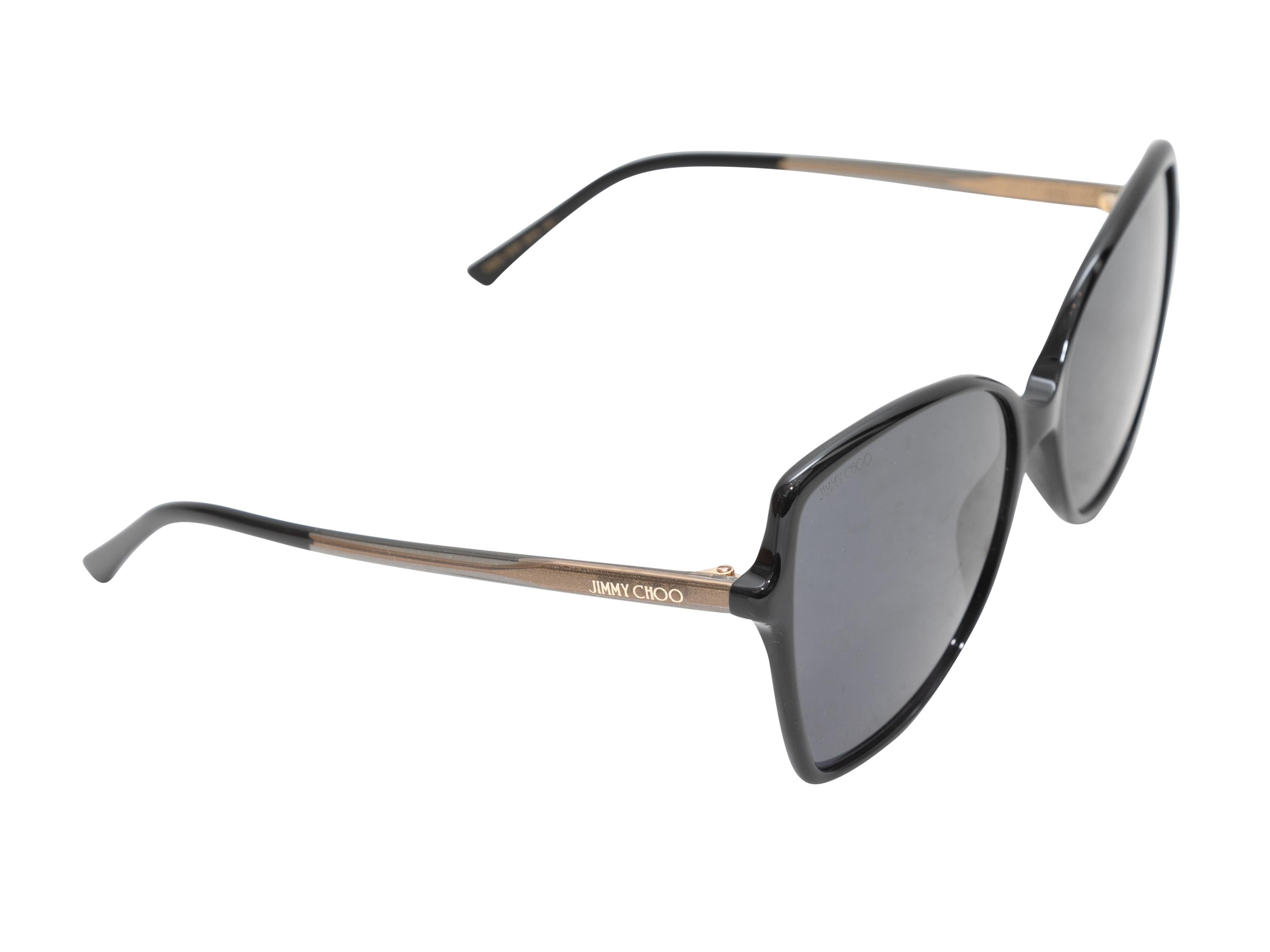 Black oversized sunglasses by Jimmy Choo. Grey tinted lenses. 2.25