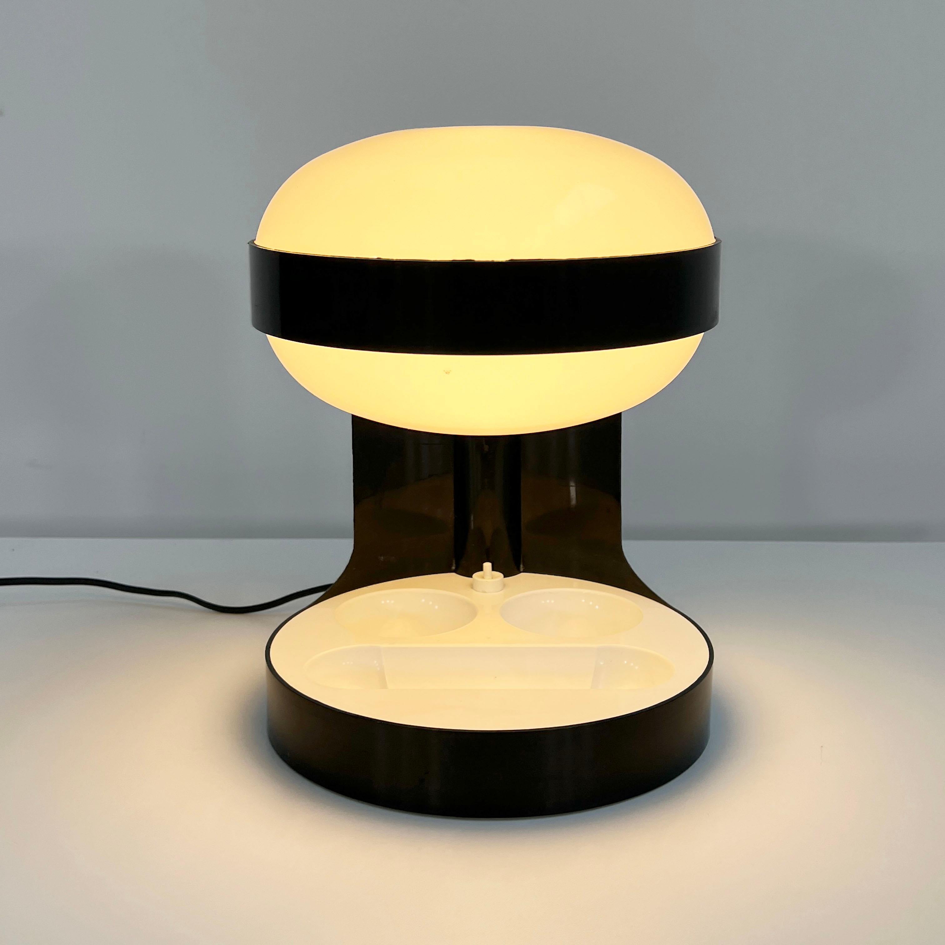 Designer - Joe Colombo
Producer - Kartell
Model - KD 29
Design Period - Seventies
Measurements - Width 25 cm x Depth 25 cm x Height 34 cm
Materials - Plastic
Color - Black, White
Electrical Properties - European Plug (up to 240V) / Lightbulb