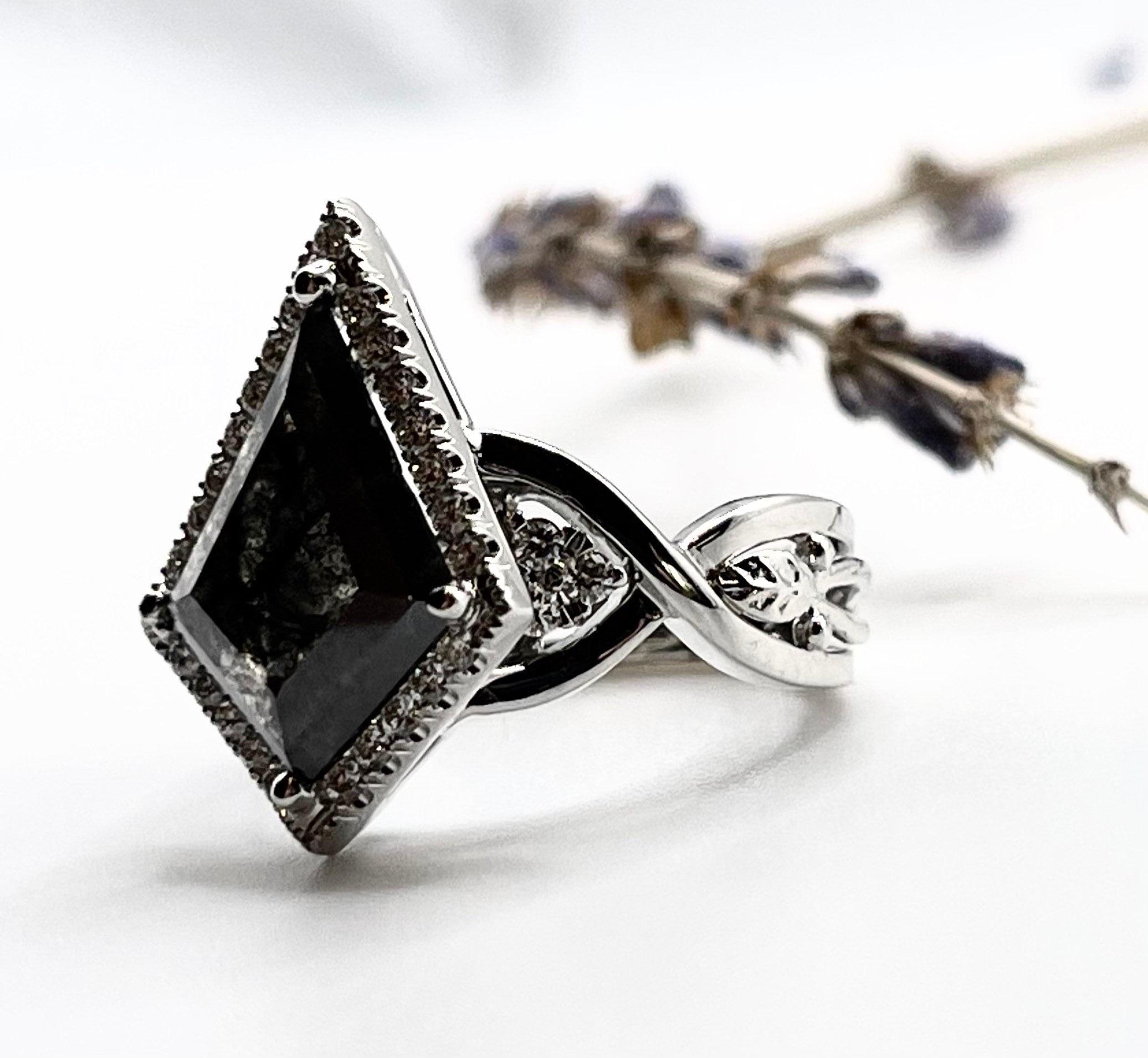 Rare find! Stunning engagement ring with a large kite diamond in the middle and fine diamonds VS-SI clarity and F-G color made in 18KT white gold, hand engraved with so many little details and floral leafs on the side. Very interesting diamond ring!
