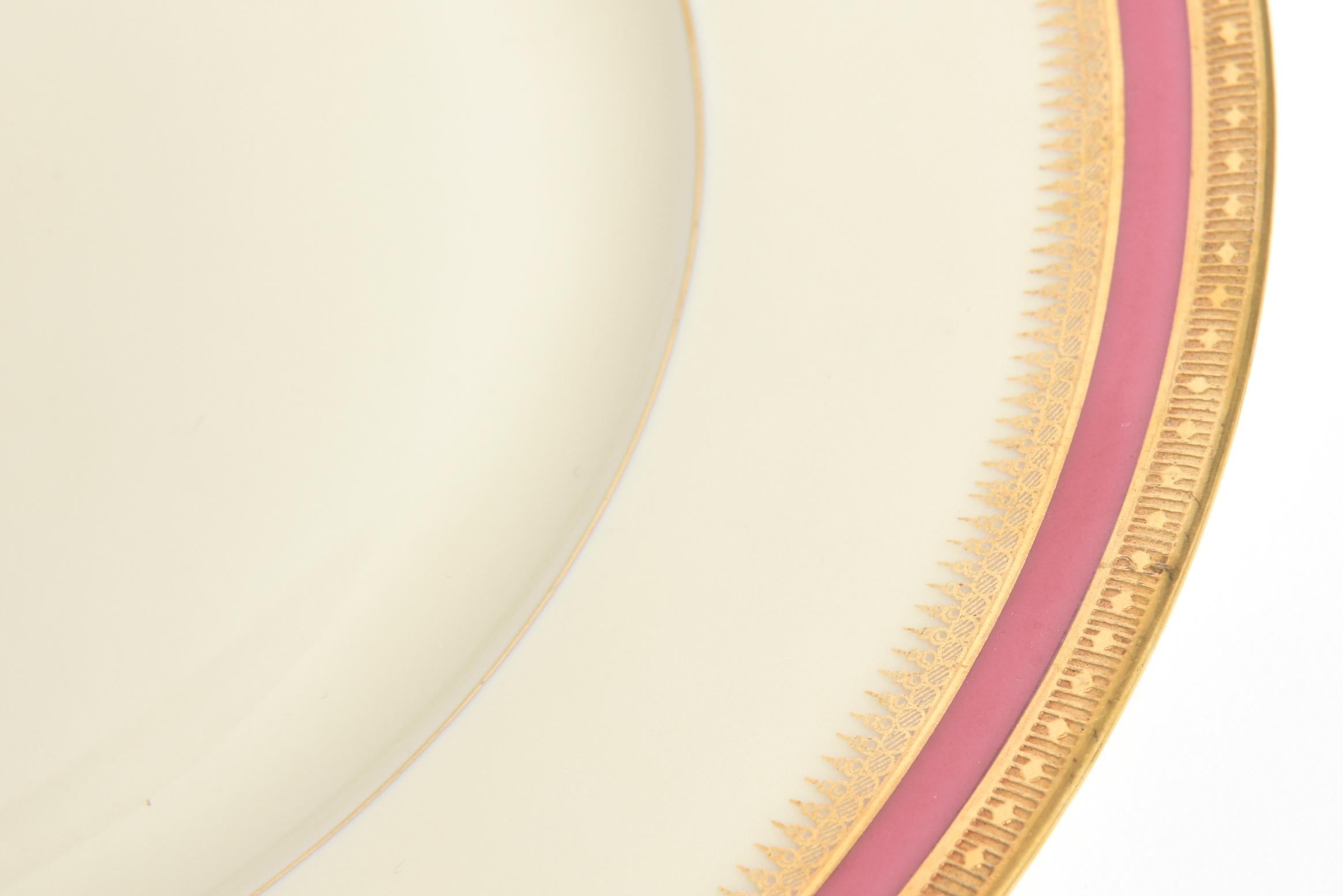 Set of eight black knight Celeste salad plates, each featuring a pink band flanked by encrusted gold banding. The stamp on the back dates the plates between 1925-1941. Stamped on underside: Black Knight Registered USA Honhenberg Bavaria. Age wear,