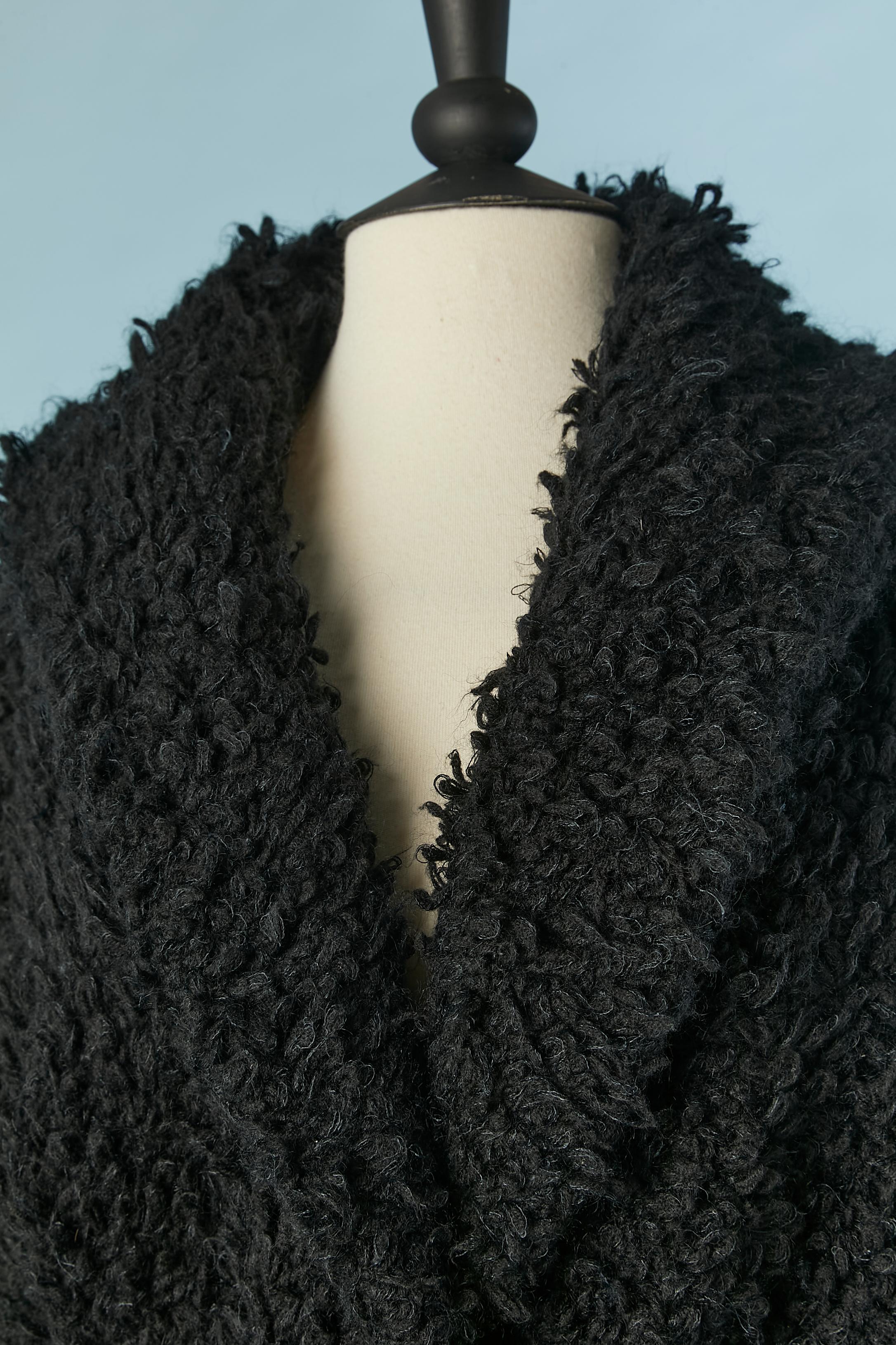 Black knit bouclette coat with knit belt . Knit composition: 60% wool, 20% mohair, 10% angora, 10% polyamide. 
SIZE 40 