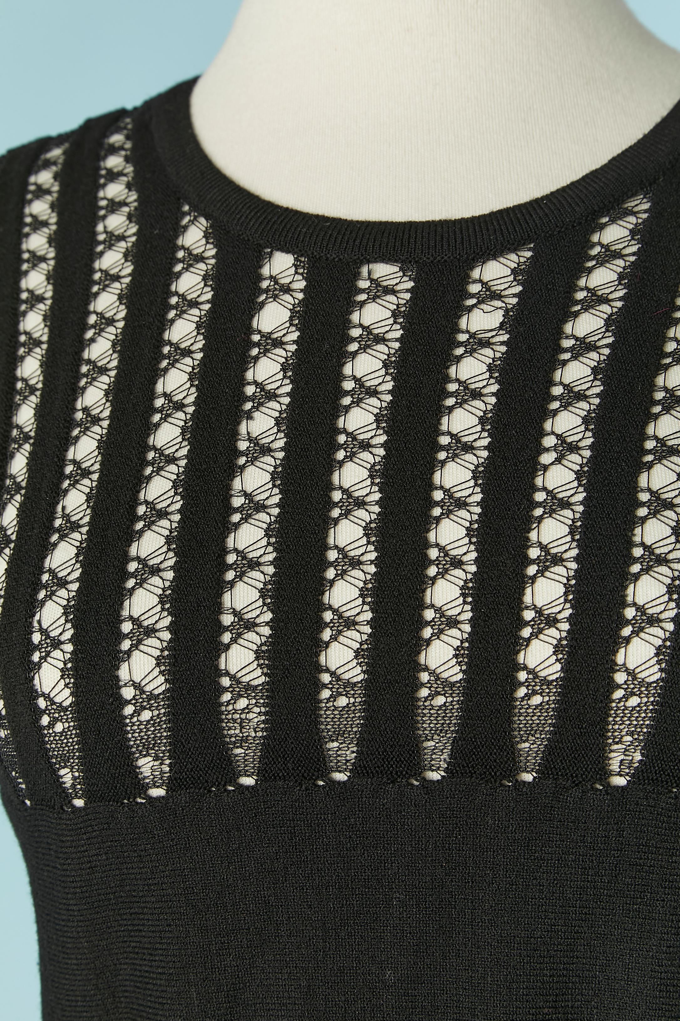 Black knit dress see-through on some part. Black knit composition: 75% wool, 10% cotton, 10% polyester, 5% nylon. Pink silk lining inside the skirt. (see-through on the shoulders, breast and sleeves) 
SIZE 40 (It) 36 (Fr) S 