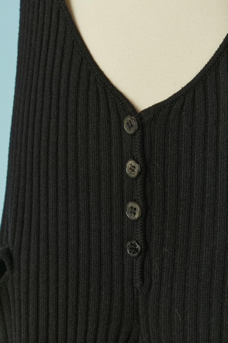 Salopette in maglia nera con tasca su entrambi i lati. Composizione della maglia: 90% lana, 10% cashmere.
Bottone e asola con marchio sul retro. 
TAGLIA M/L 