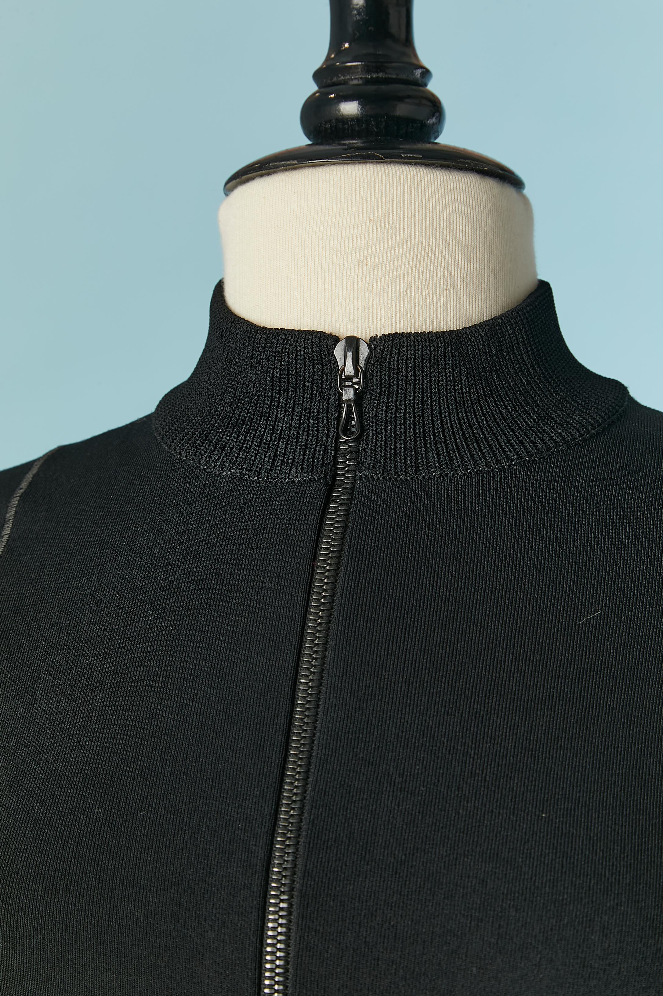 Black knit jersey jacket and trouser ensemble. Knit jersey composition: 94% rayon, 6% polyester. 
Zip closure on the middle front . Cut-work. 
SIZE M 
New with tag 