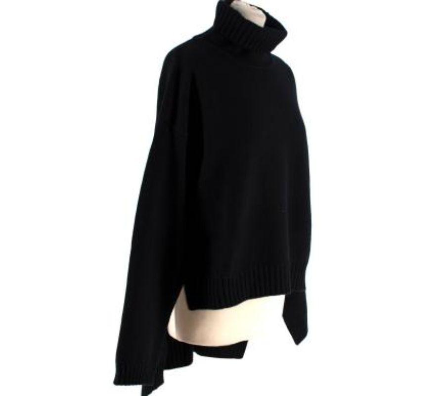 Tom Ford Black Knit Roll Neck High Low Length
 

 - Luxurious cashmere sweater with fold over turtle neck
 - Ribbed collar, waistband and wrist cuffs
 - Cropped in front and long in back 
 

 Materials 
 100% Cashmere 
 

 Made in Italy
 

 PLEASE