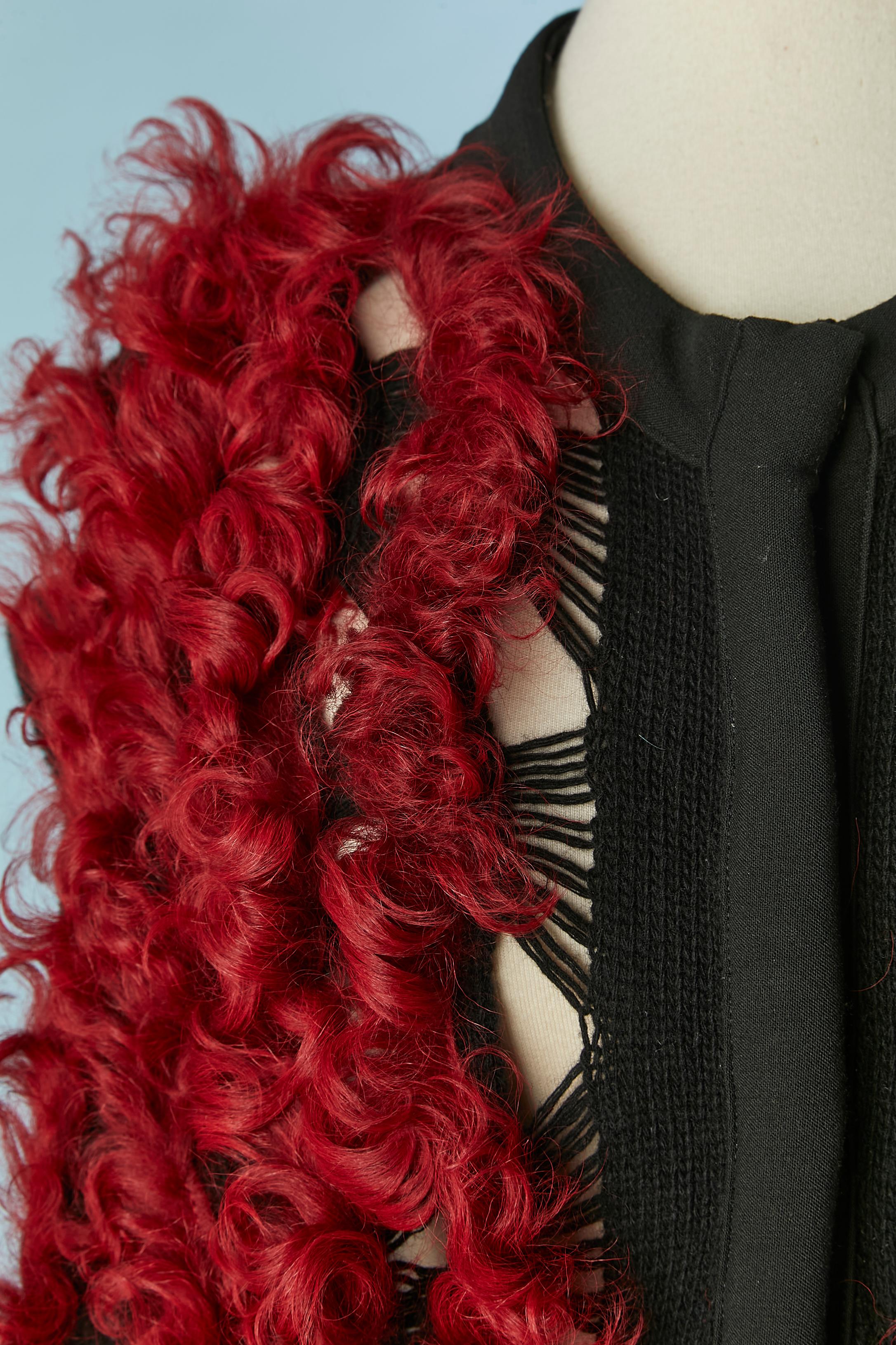Black knit sleeveless vest with red curly furs appliqué. No fabric tag composition but the knit is probably wool and furs is lamb. Large snap closure in the middle front. 
Limited Edition
SIZE M 