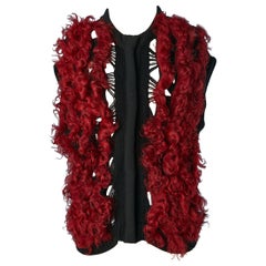Black knit sleeveless vest with red curly furs appliqué Paolo Errico