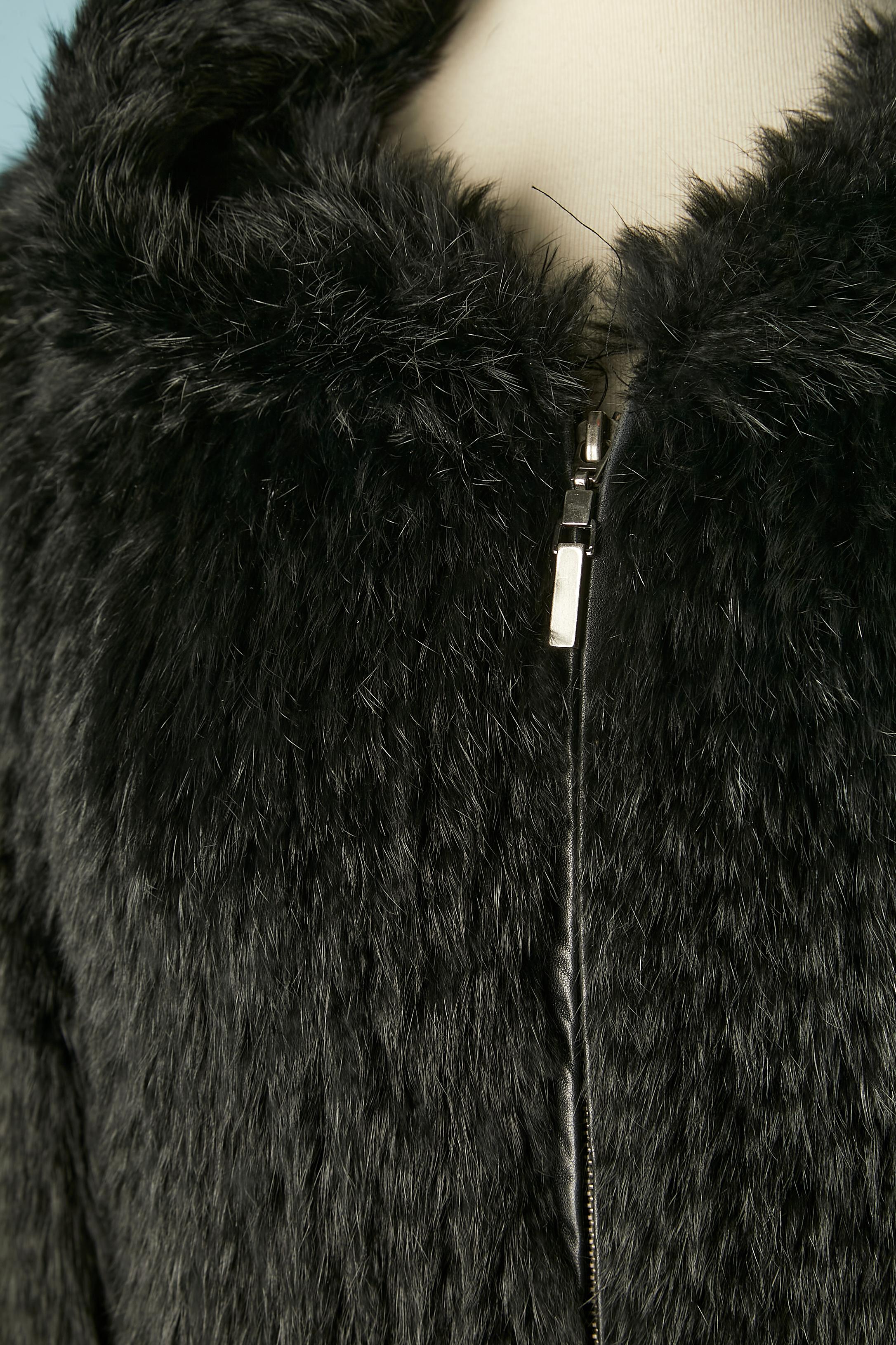 Black knitted rabbit fur coat with hood and zip closure. Leather along the zip in the middle front. Leather piping along the pockets. Ribbed knit in the bottom. 
Size M on tag but fit also L 