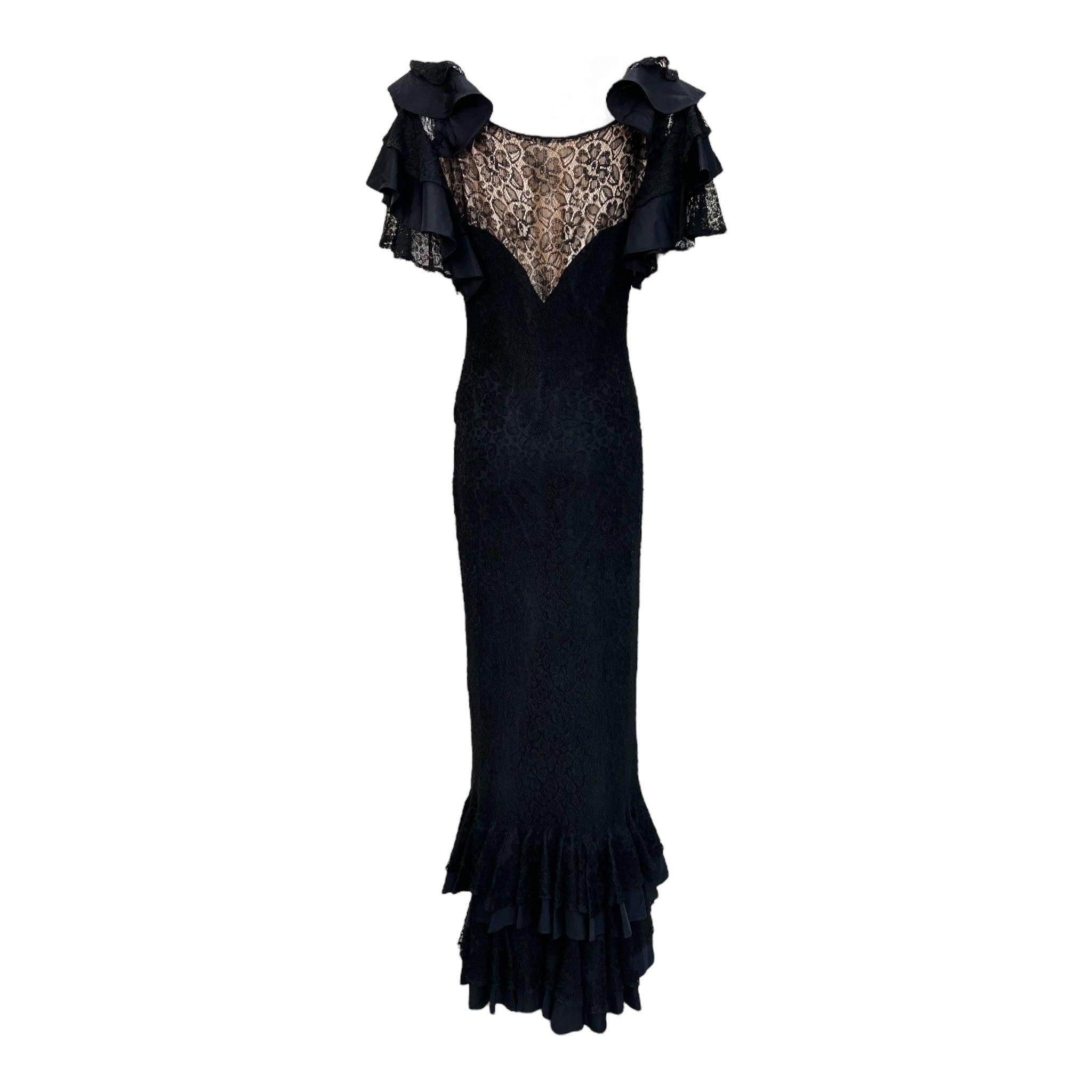 Magnificent 1930's black lace gown. Black lace overlay on a black slip with beige detail at the bodice and back. Sculptural tiers of layered lace and black acetate create the dramatic flutter sleeve silhouette. This motif is repeated in the tiered