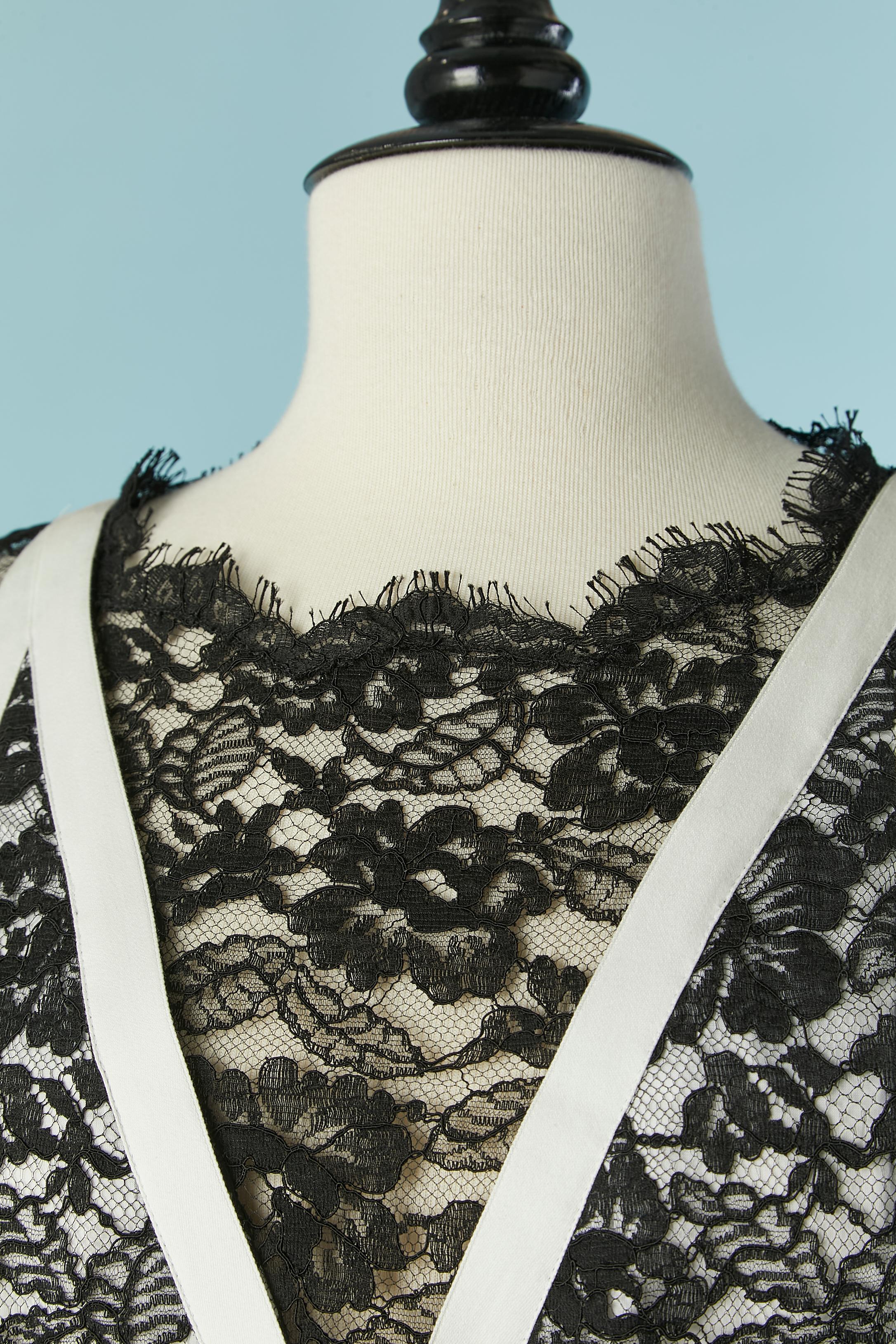 Black lace evening dress with white piping and white cotton lining. 
Lace composition: 52% cotton, 32% rayon, 16% nylon. Invisible zip on he middle back + hook&eye on the top middle back. Decorative pocket on the hips. Small metallic brand on the
