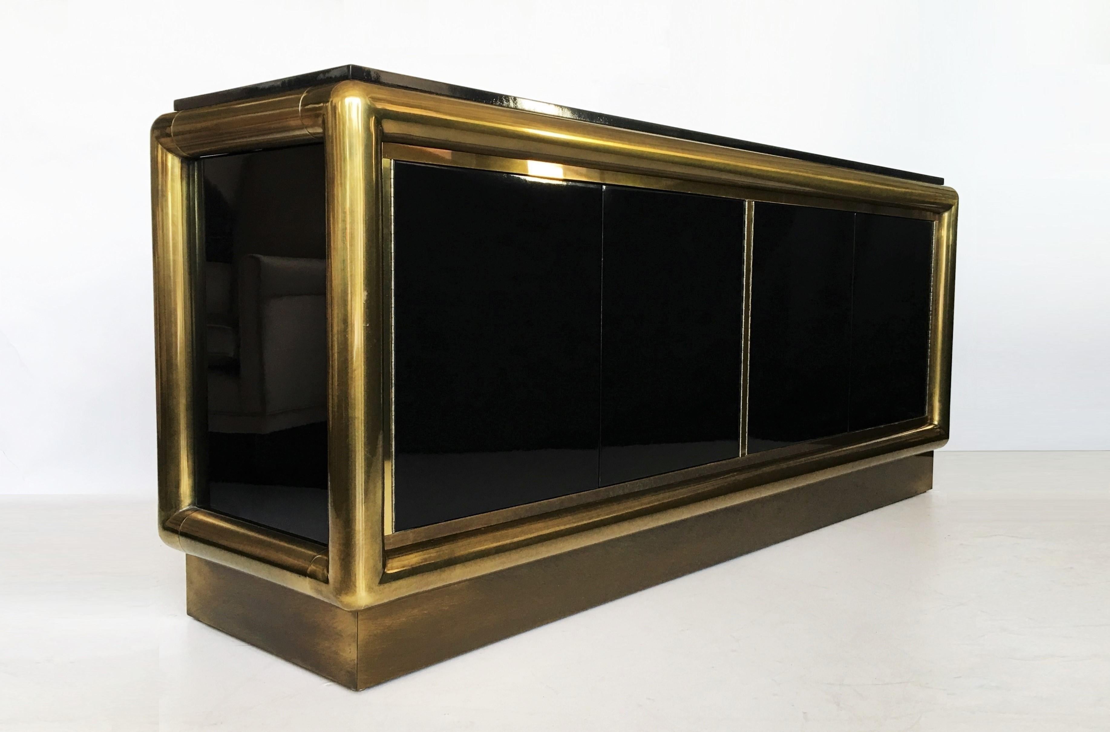 Glamorous one-of-a-kind piece designed by the great Mastercraft in Grand Rapids. Features a massive tubular brass framed body, both sides have a gentle curve. Top and sides are finished in black lacquer with graphic brass trim pieces and back is