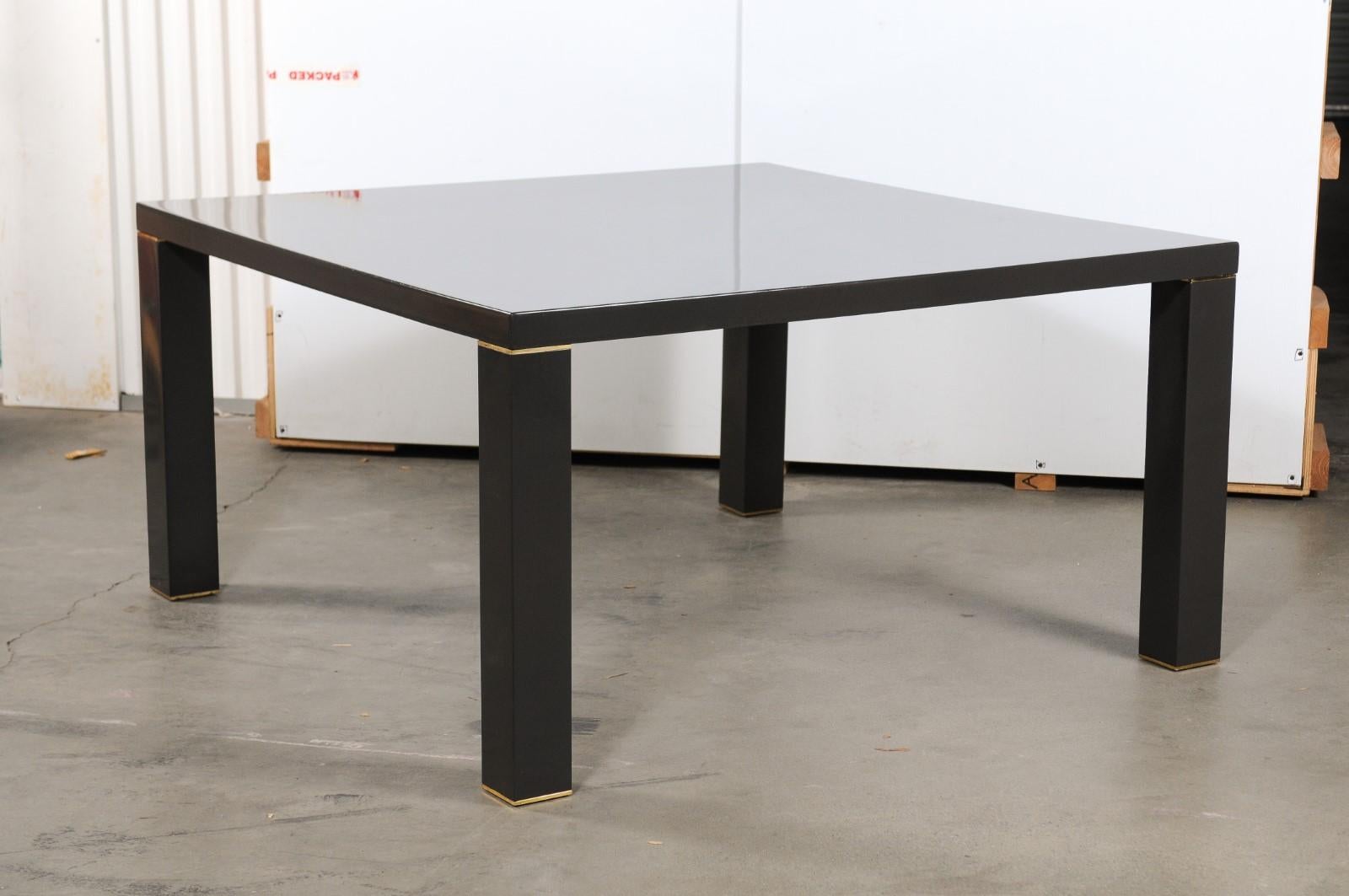 Superb modern dining table featuring black lacquer over wood with brass accents. Attributed to Karl Springer, 1980s. Measures: 29
