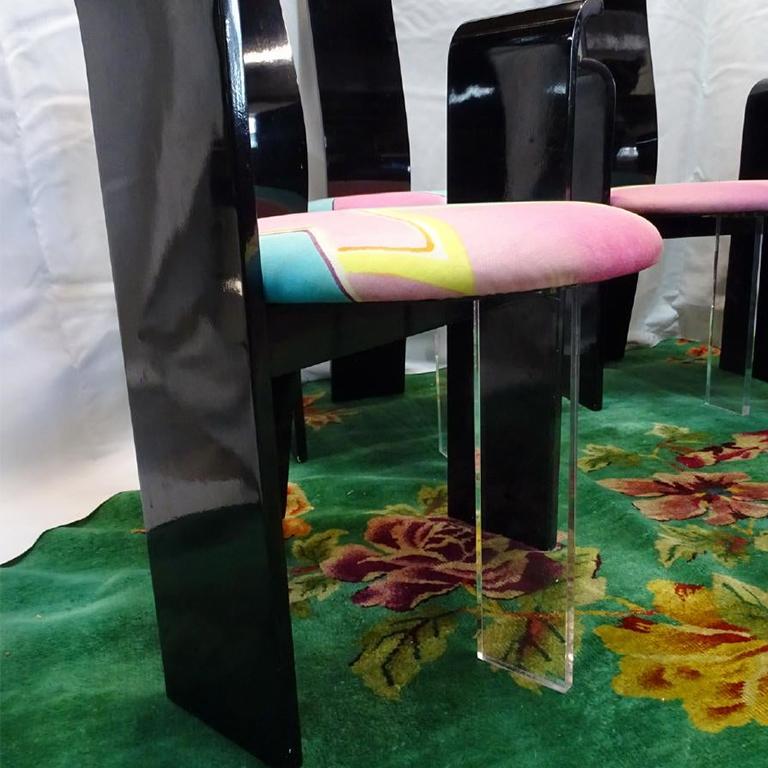 Mid Century Modern, Bauhaus or Memphis style black lacquer chairs, a set of 4. High backs and rounded waterfall arms. Round seat cushions upholstered in a pink yellow and blue Memphis / Maximalism style geometric pattern. 

These would be great as