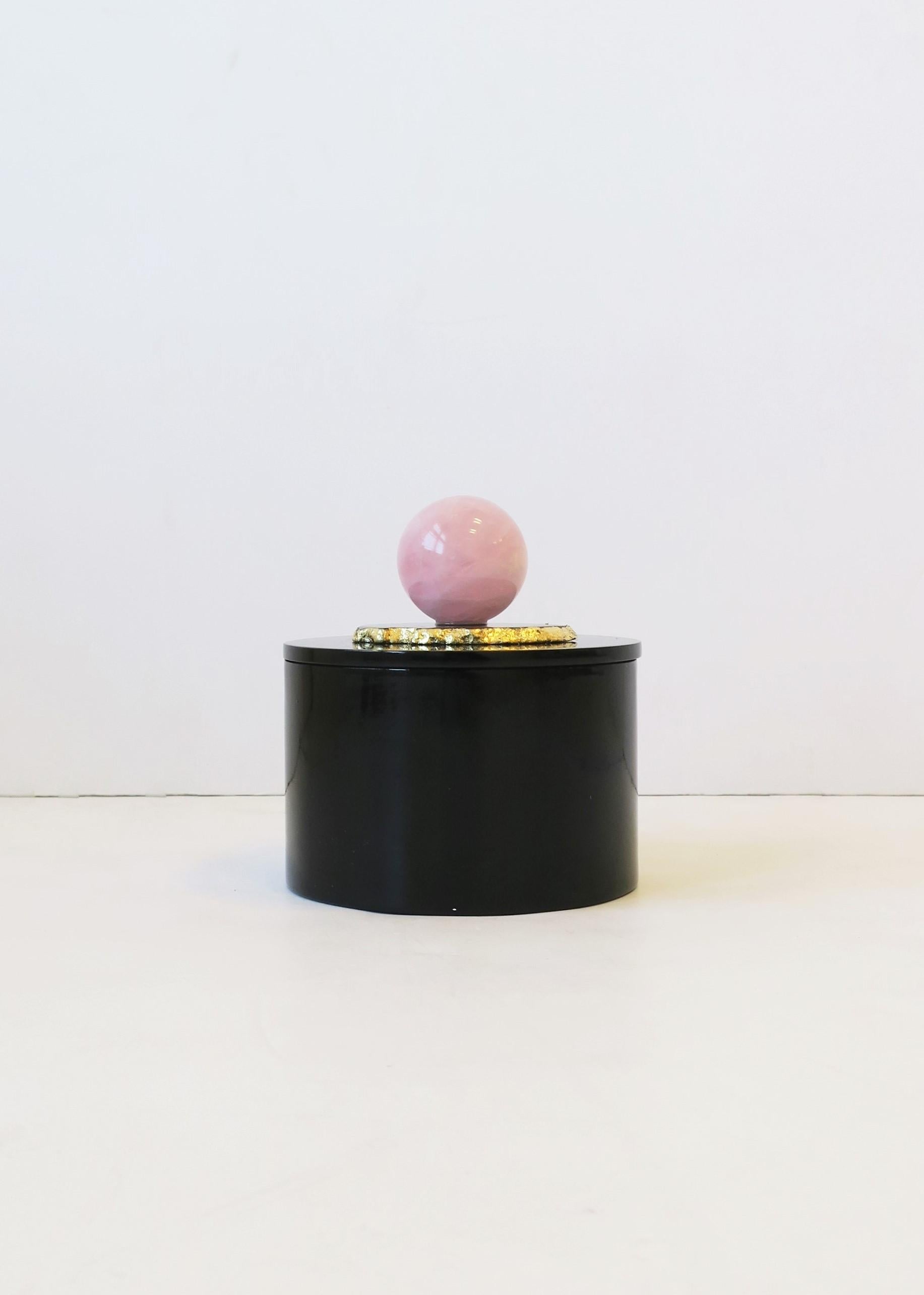 A round black lacquer box with gold dipped agate and rose quartz decorated lid. A great piece for a vanity, bathroom, office/desk, etc. Dimensions: 4.75