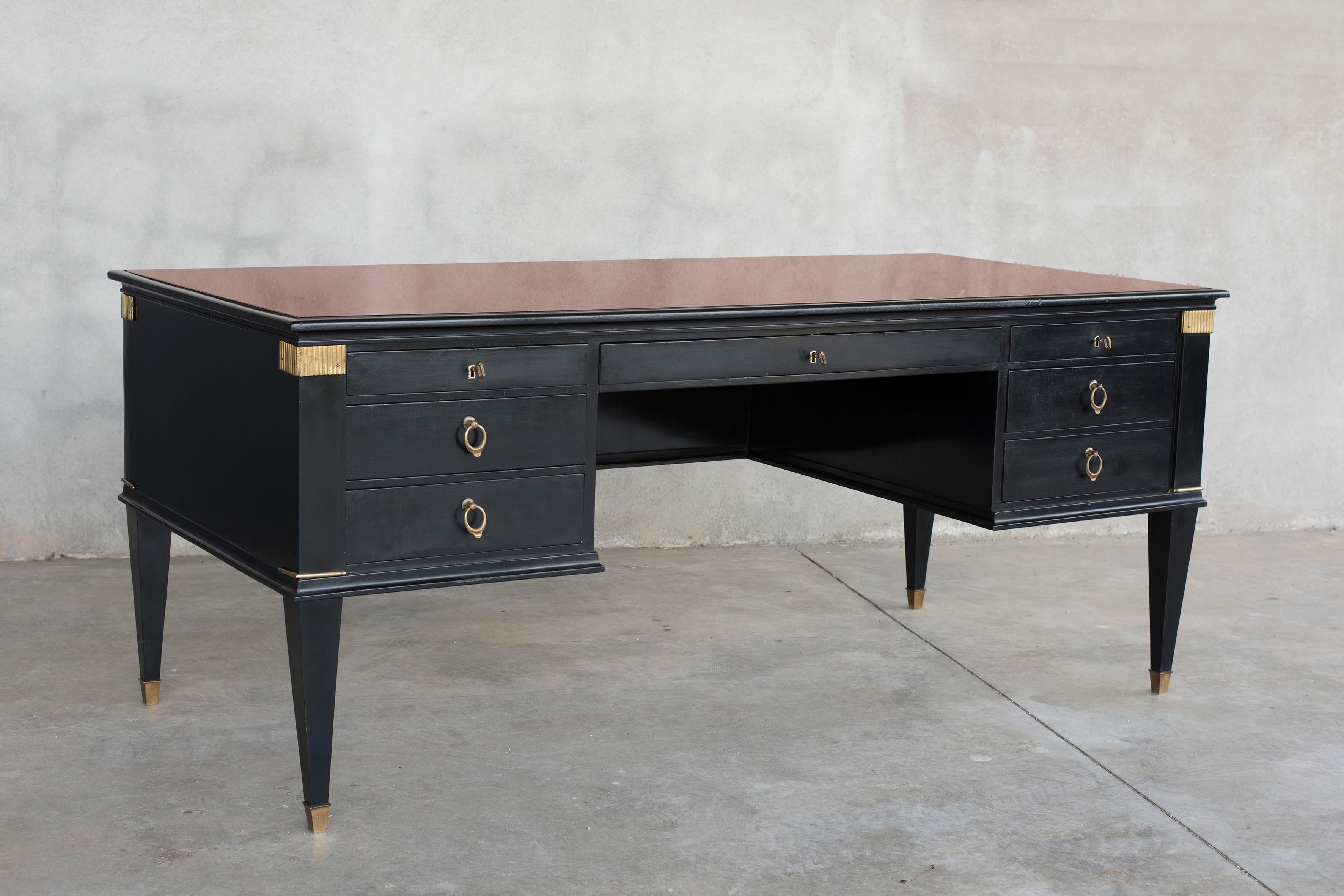 Black lacquer bronze details diplomatic desk with crystal over a leather top.
This desk features 7 drawers with bronze handles and squared bronze feet.
This piece of furniture has been realized in XX century according Louis XVI style.
Its size