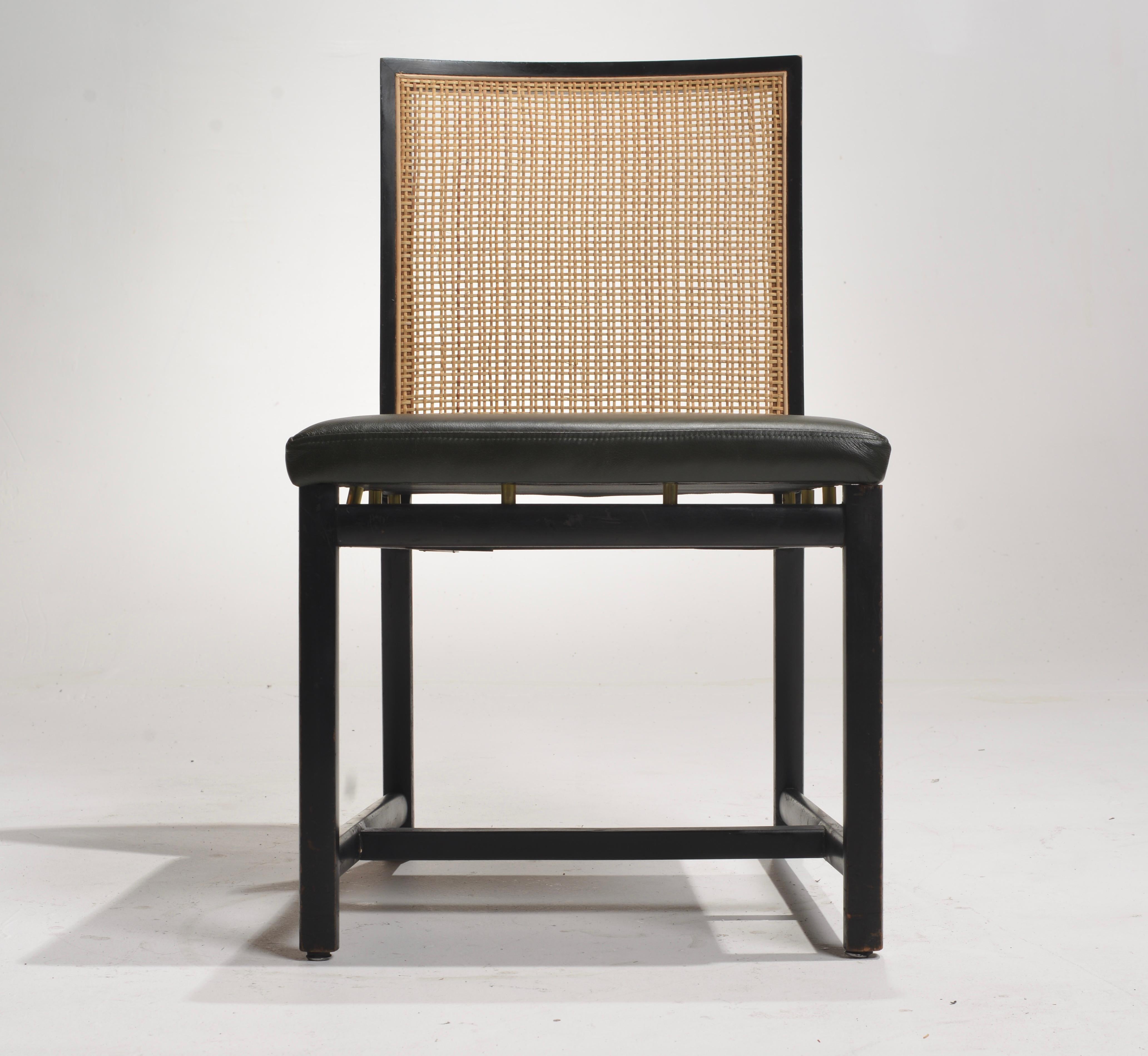 The Black Lacquer Cane Back Dining Chairs by Michael Taylor for Baker feature a sleek black lacquer finish. The cane backrests seamlessly blend traditional craftsmanship with contemporary design. Michael Taylor's visionary approach to luxury is
