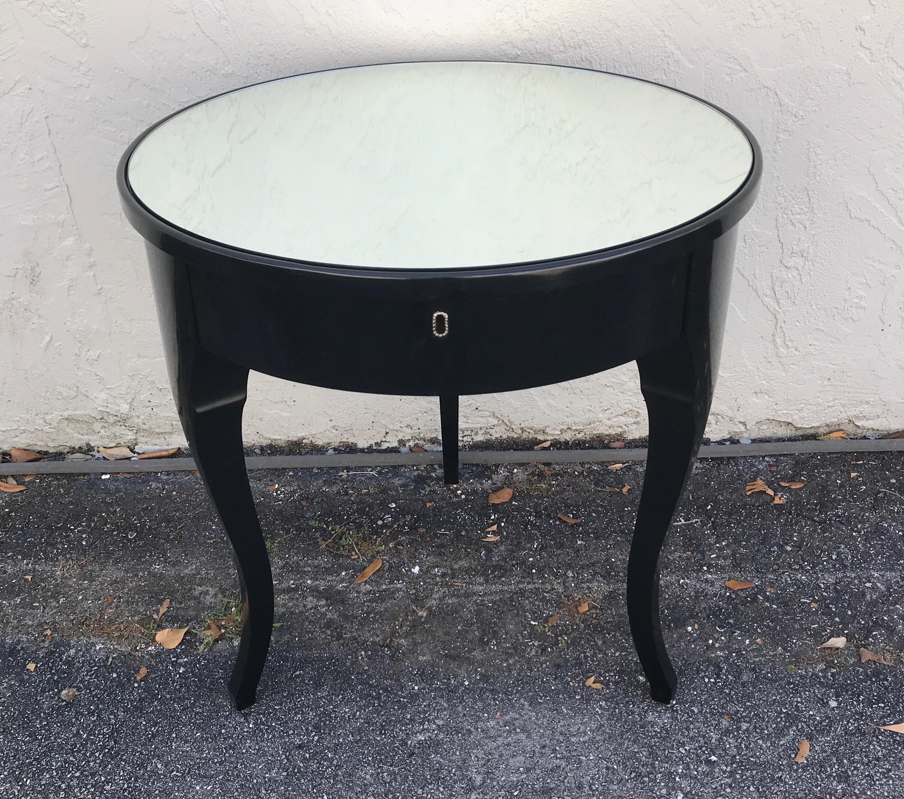 Charles X style black lacquered side table with three tapering legs, single drawer & mirrored top.