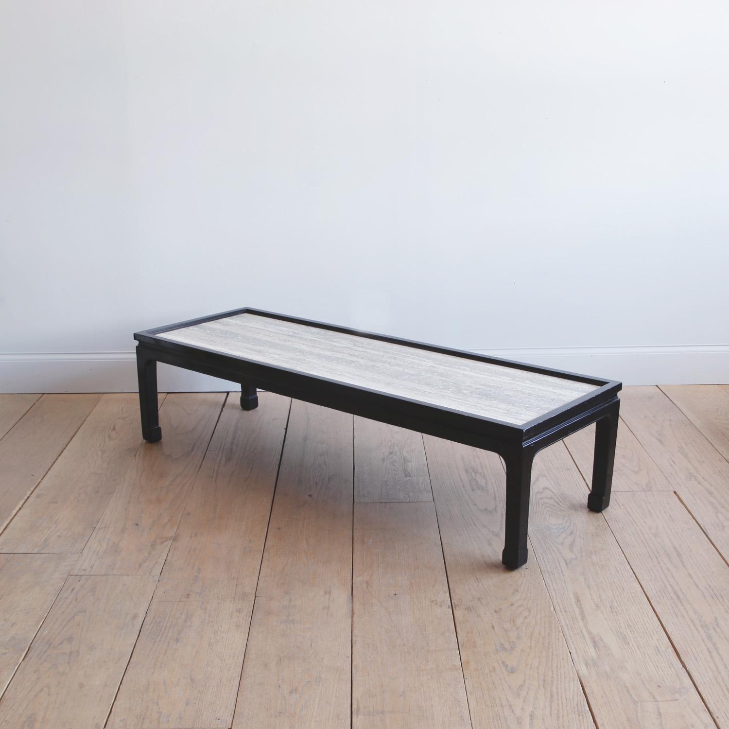 A black lacquer midcentury coffee table with an elegant Chinese profile. We have recently replaced the top with a painterly piece of travertine. We find the stone to be a worthy object of contemplation.
  
