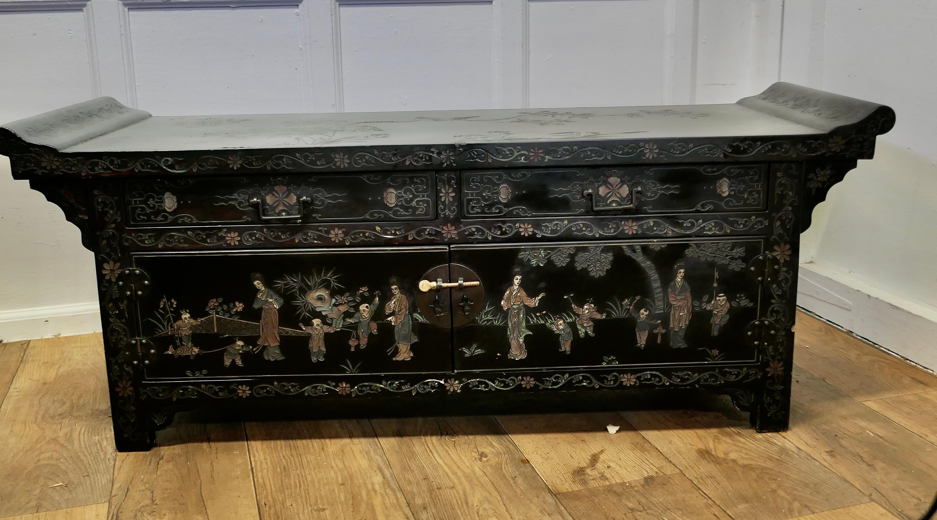 Black Lacquer Chinoiserie Low Cabinet, Coffee Table

This is a delightful Oriental Cabinet, it is both Long and low and is designed to be used as both cabinet and as a low dining table
The cabinet has a long 2 door cupboard and 2 wide drawers over,