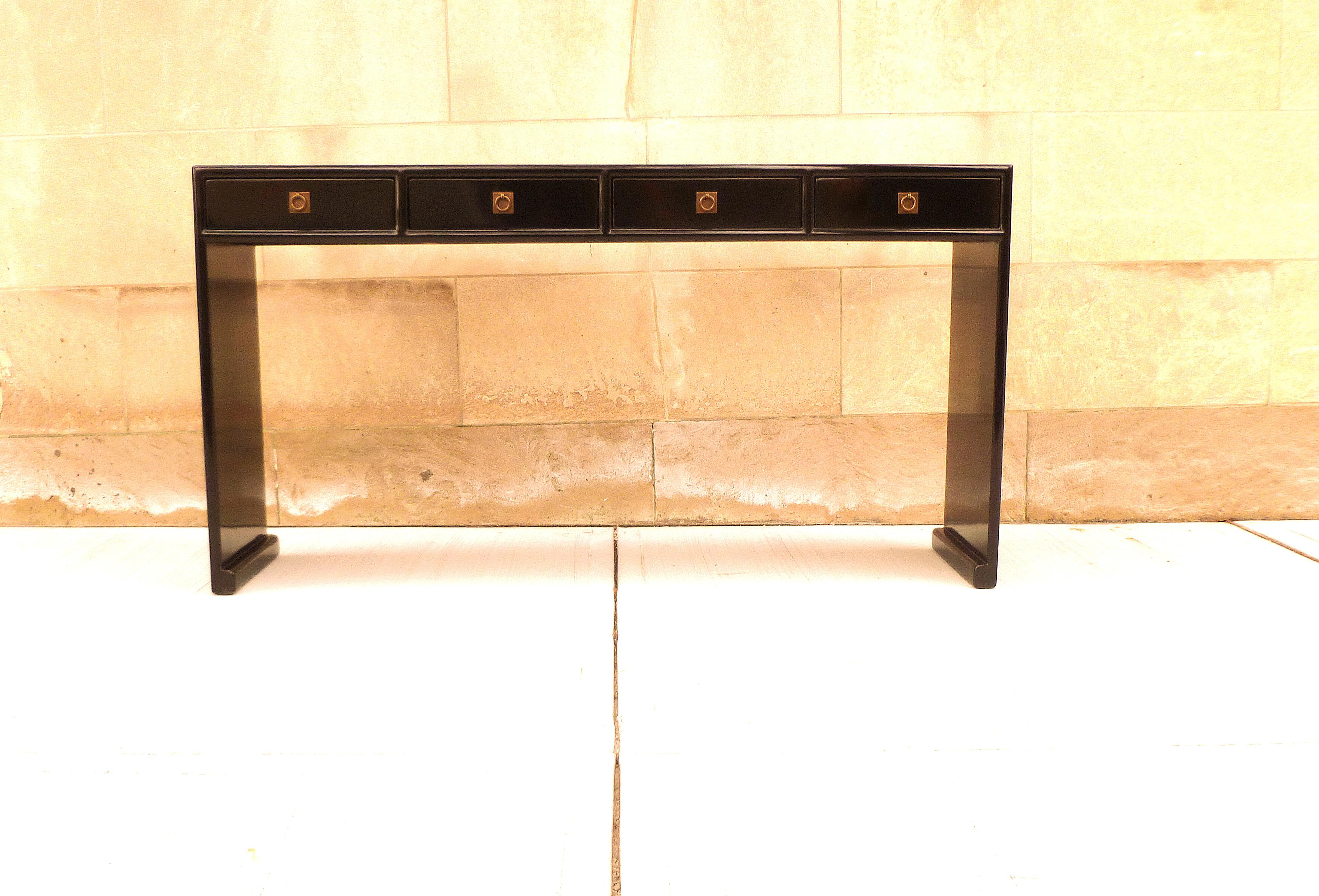 Black lacquer console table with four drawers, waterfall legs, brass fitting, elegant and simple form, beautiful lines.