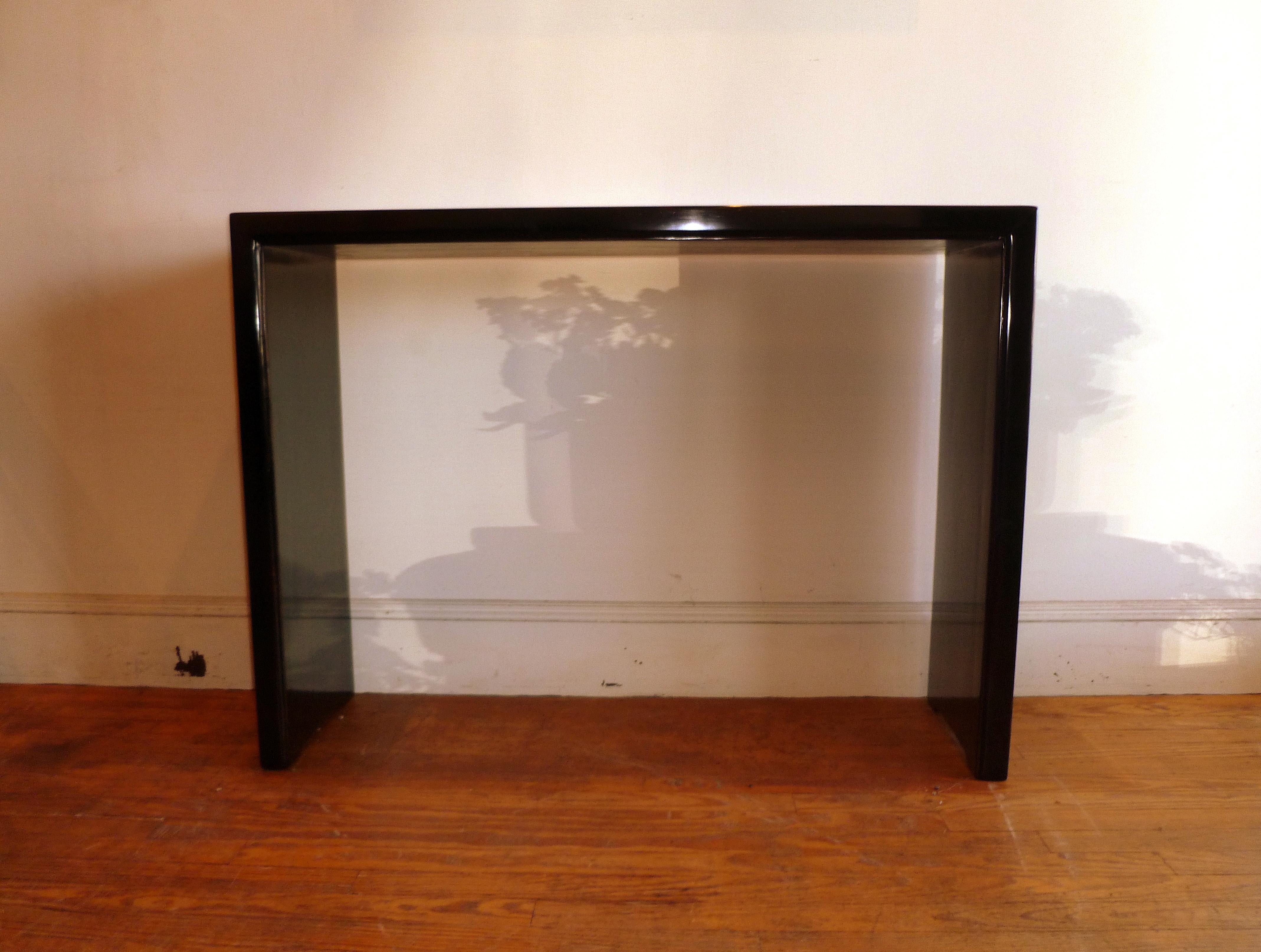 Simple black lacquer console table with waterfall legs, elegant color and lines
