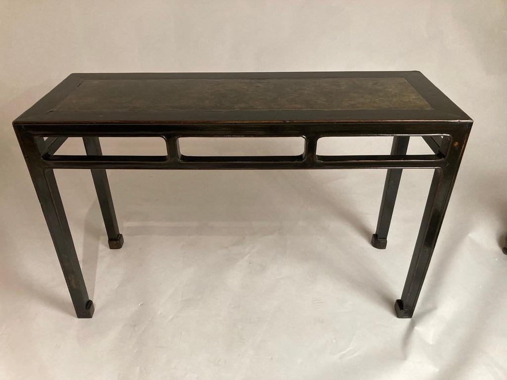 A fine Chinese black lacquered altar table with inlaid sponge painted marble top. The minimalist profile gives this antique piece a very modern feel. A great fit for traditional and contemporary interiors. 
51 inches wide 32 high 18 deep.