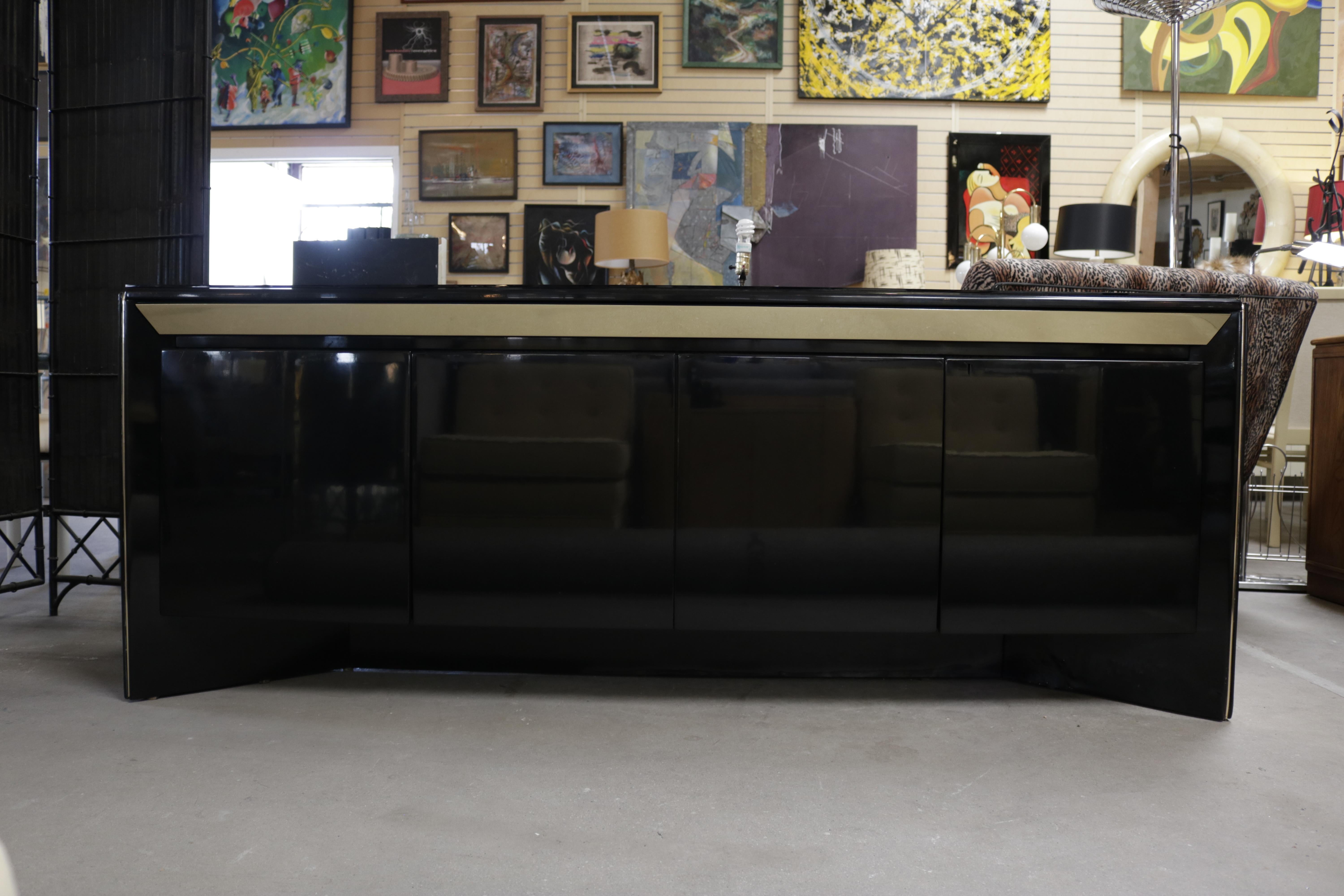 Black lacquer credenza with a standout brass band and two 2-door cabinets by Rougier.