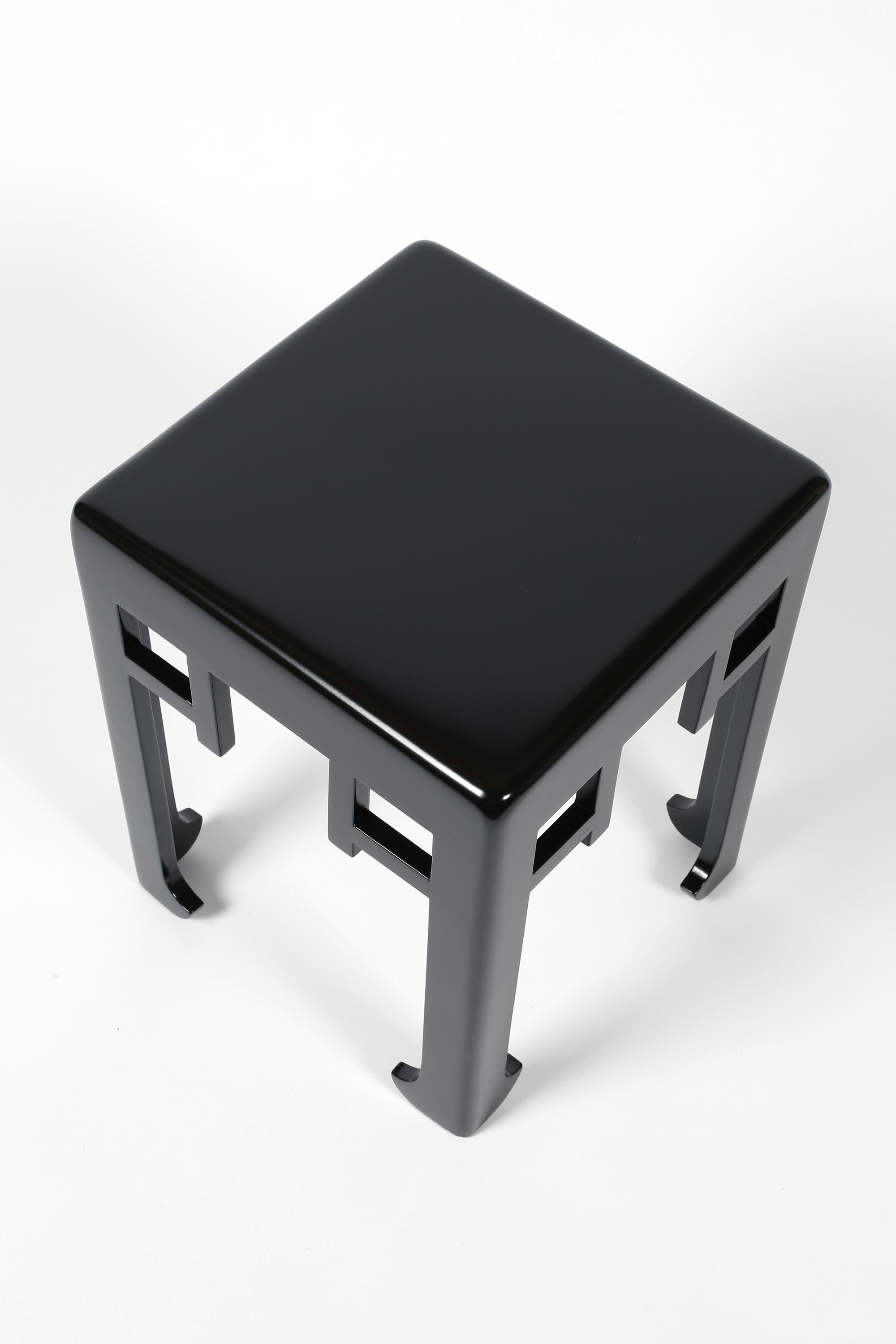 An Art Deco carved timber side table attributed to Paul Poiret (1879-1944) for Atelier Martine. Typically eastern in form, with decorative chinoiserie frieze and ‘elephant’ feet. Entirely finished in new glossy black lacquer.