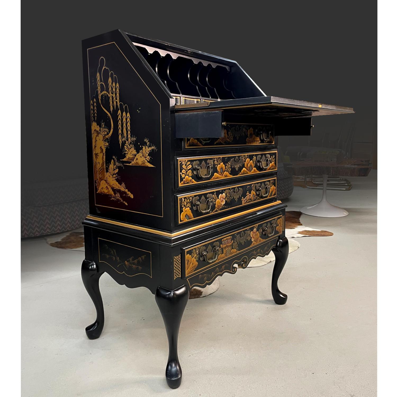 This incomparable slant-front chinoiserie black lacquer secretary desk depicts a serene, traditional Asian motif from head to toe.  The gold and greens appear as mystical and radiant as the subject itself.  

This desk is a magical treasure chest of