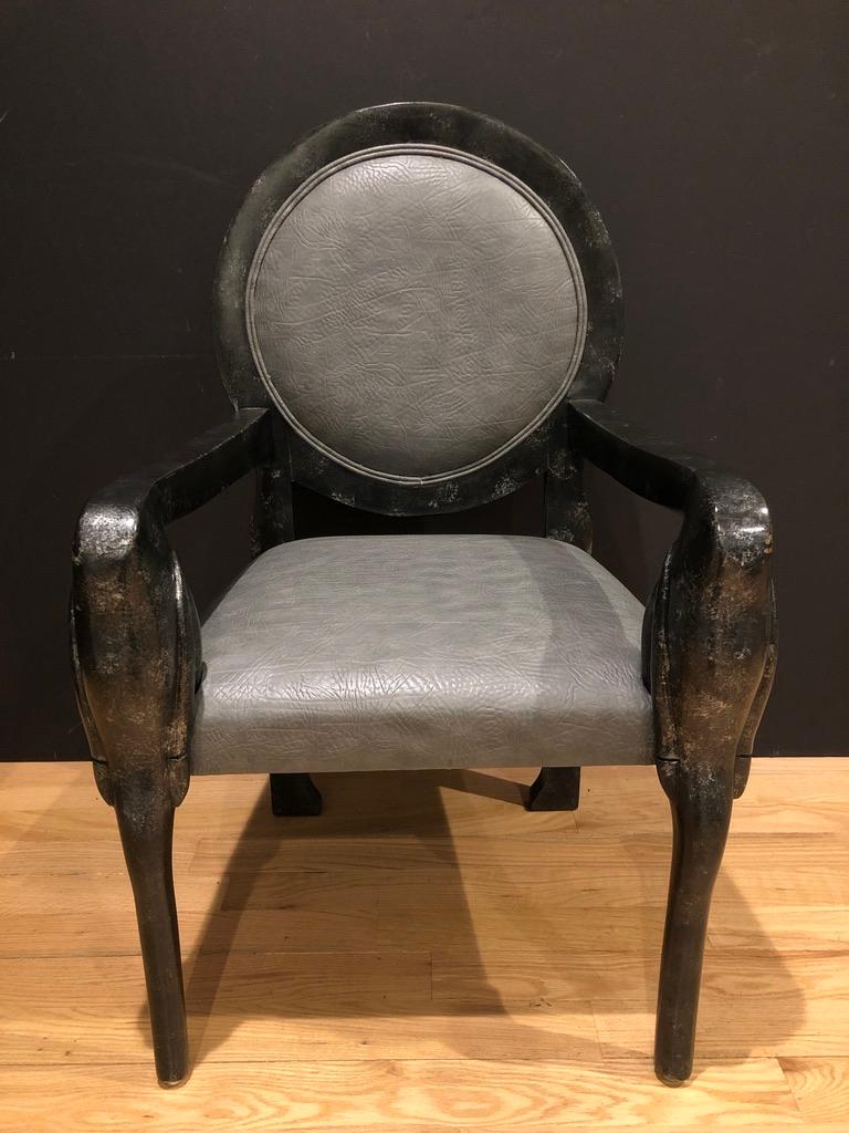 Midcentury black lacquer and silver mottled finished medallion back carved armchair. Faux gray leather upholstery.