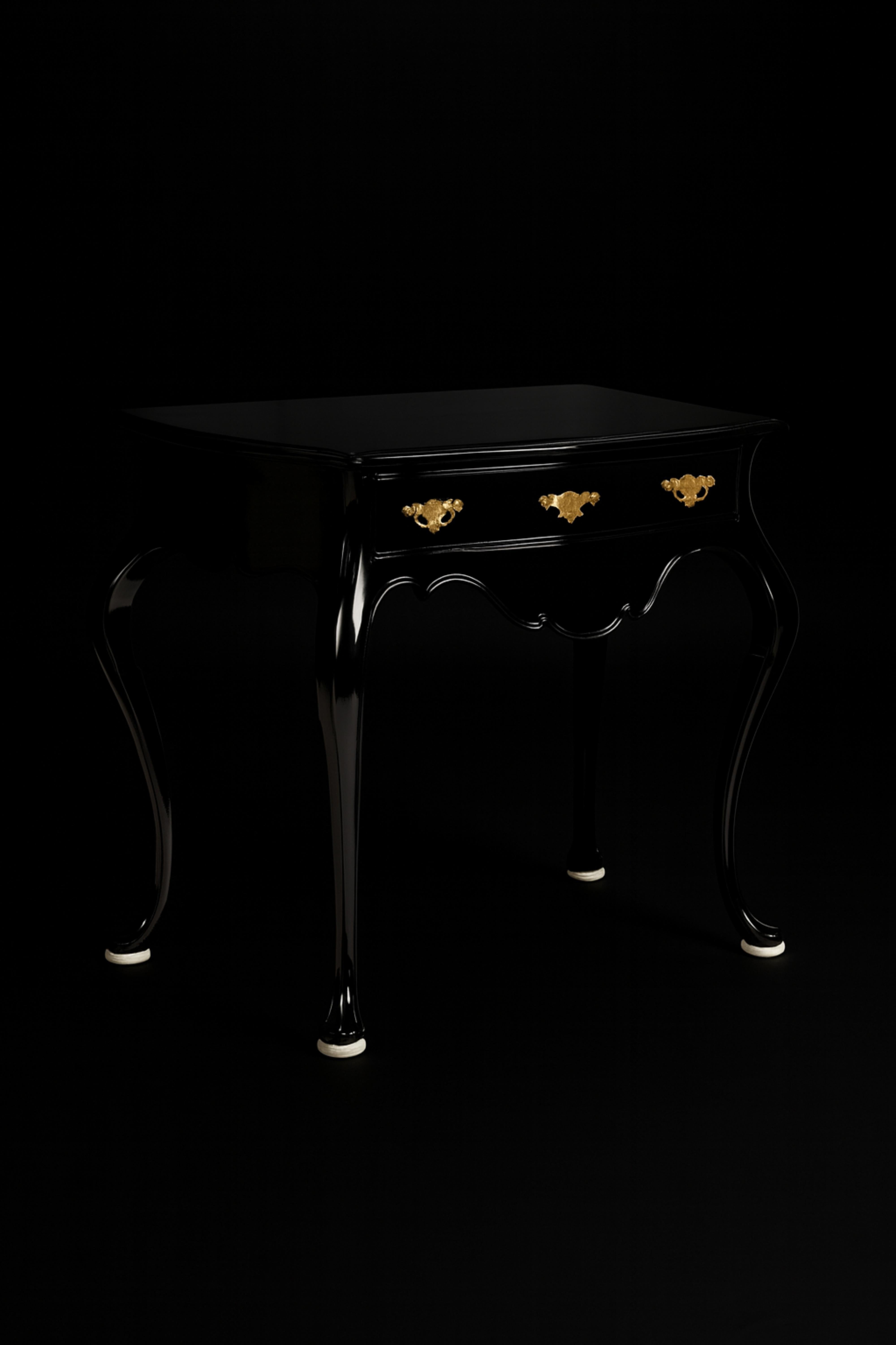 Elevate your space with this high-end Portuguese Baroque-style wood table commode refinished with off white shoes, now re-imagined in sleek black lacquer by expert artisans. Featuring a single drawer with a cut-out top that follows the elegant lines