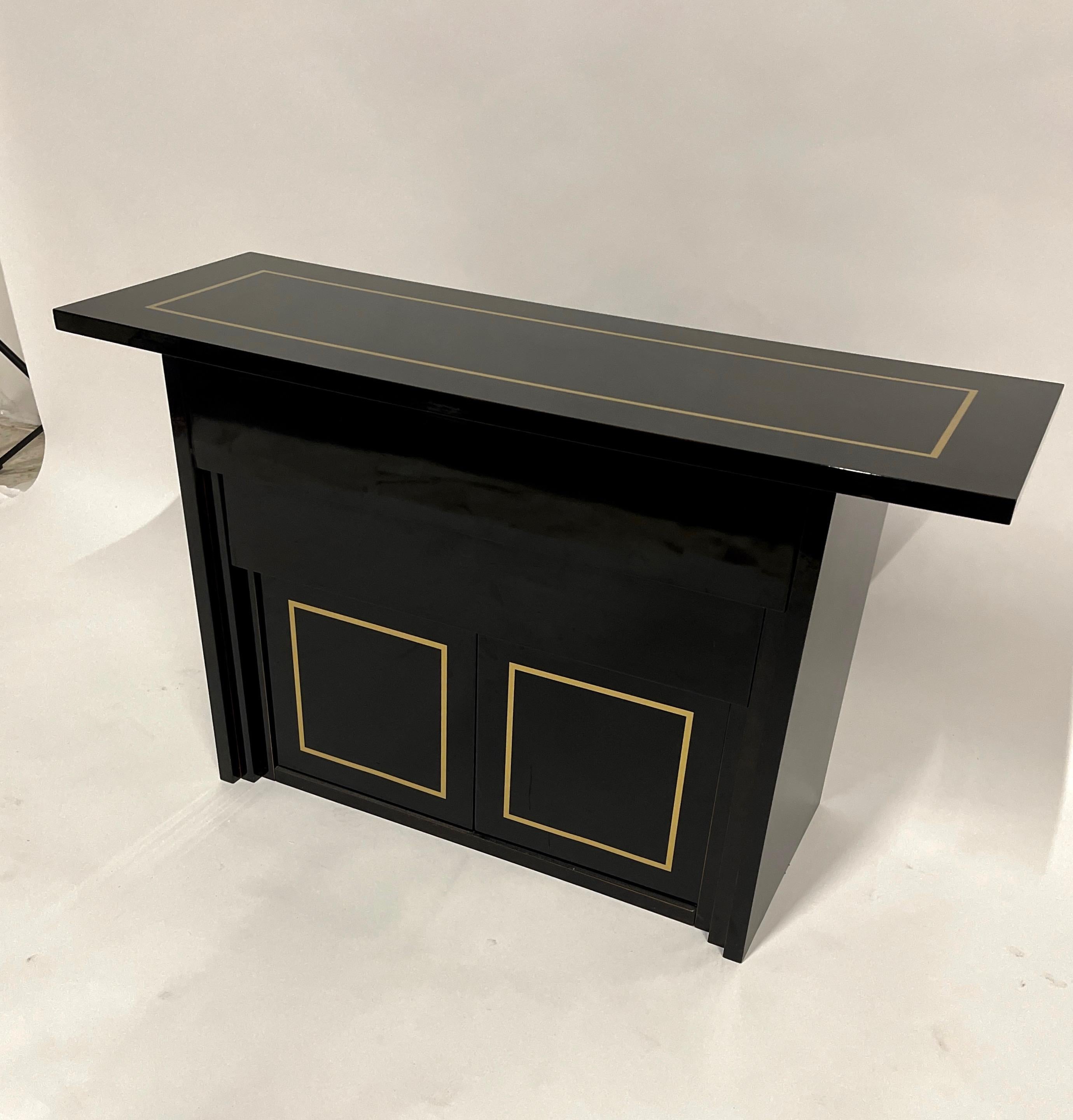 Lovely and versatile black lacquer piece. Would function well as a console, bar, buffet or credenza. Made in Italy.
2 graduated drawers and one large storage cabinet on bottom- size of opening on the bottom portion measures 31